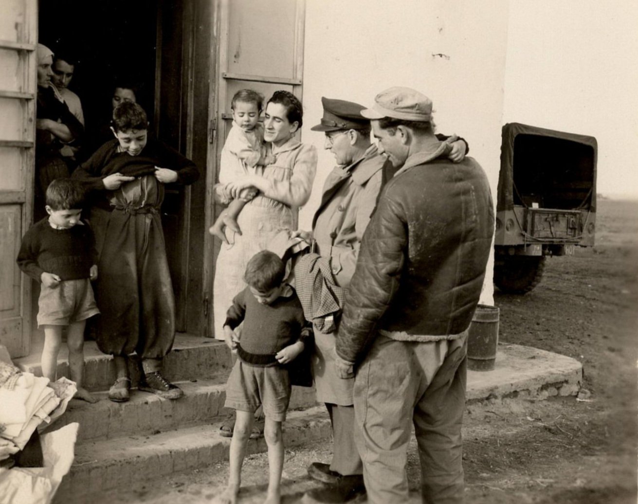 William Carrigan distributes clothing in Italy (1944 or 1945).