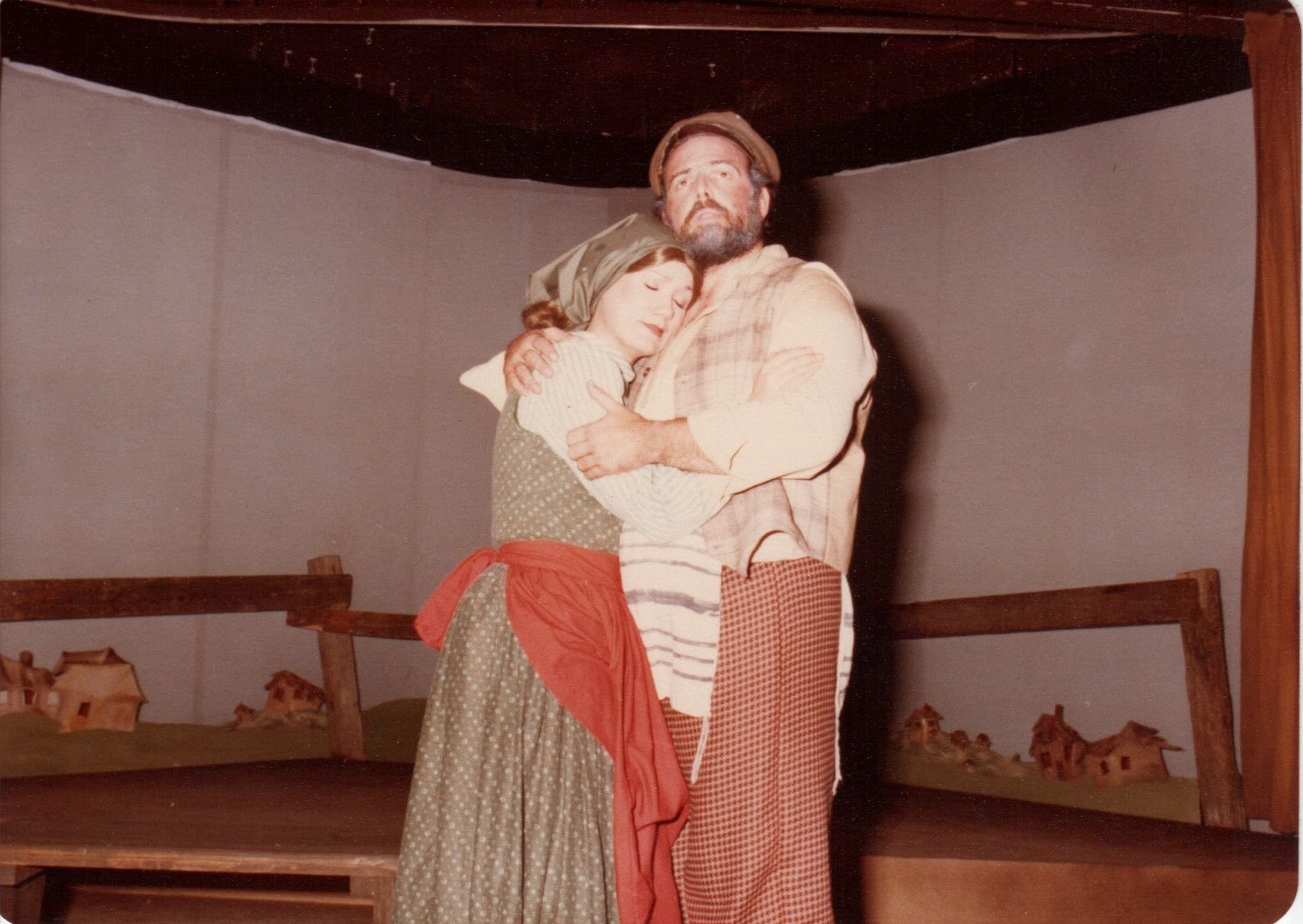 Two actors in period costumes on stage