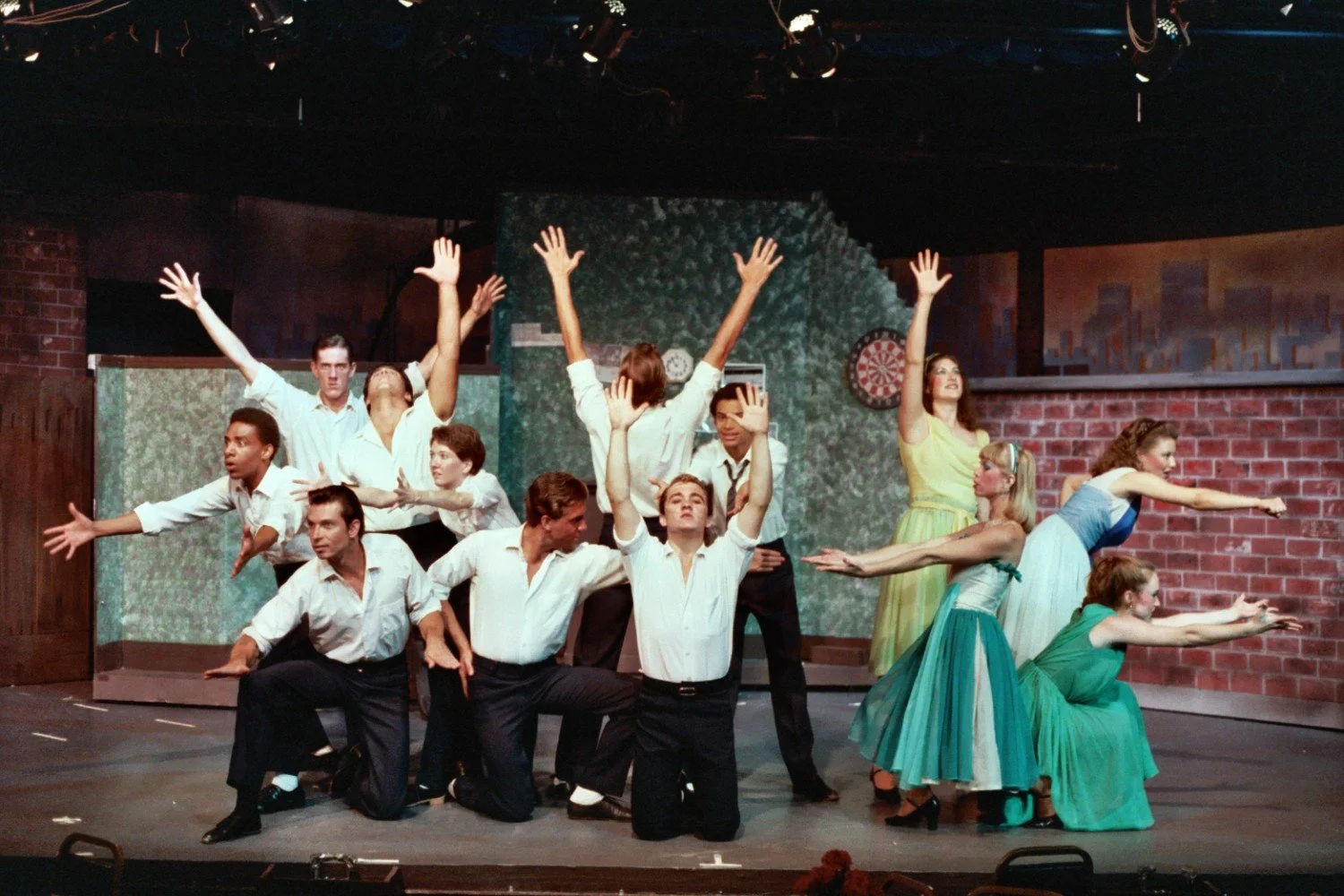 Theater performance showing dancers in choreographed formation on stage.