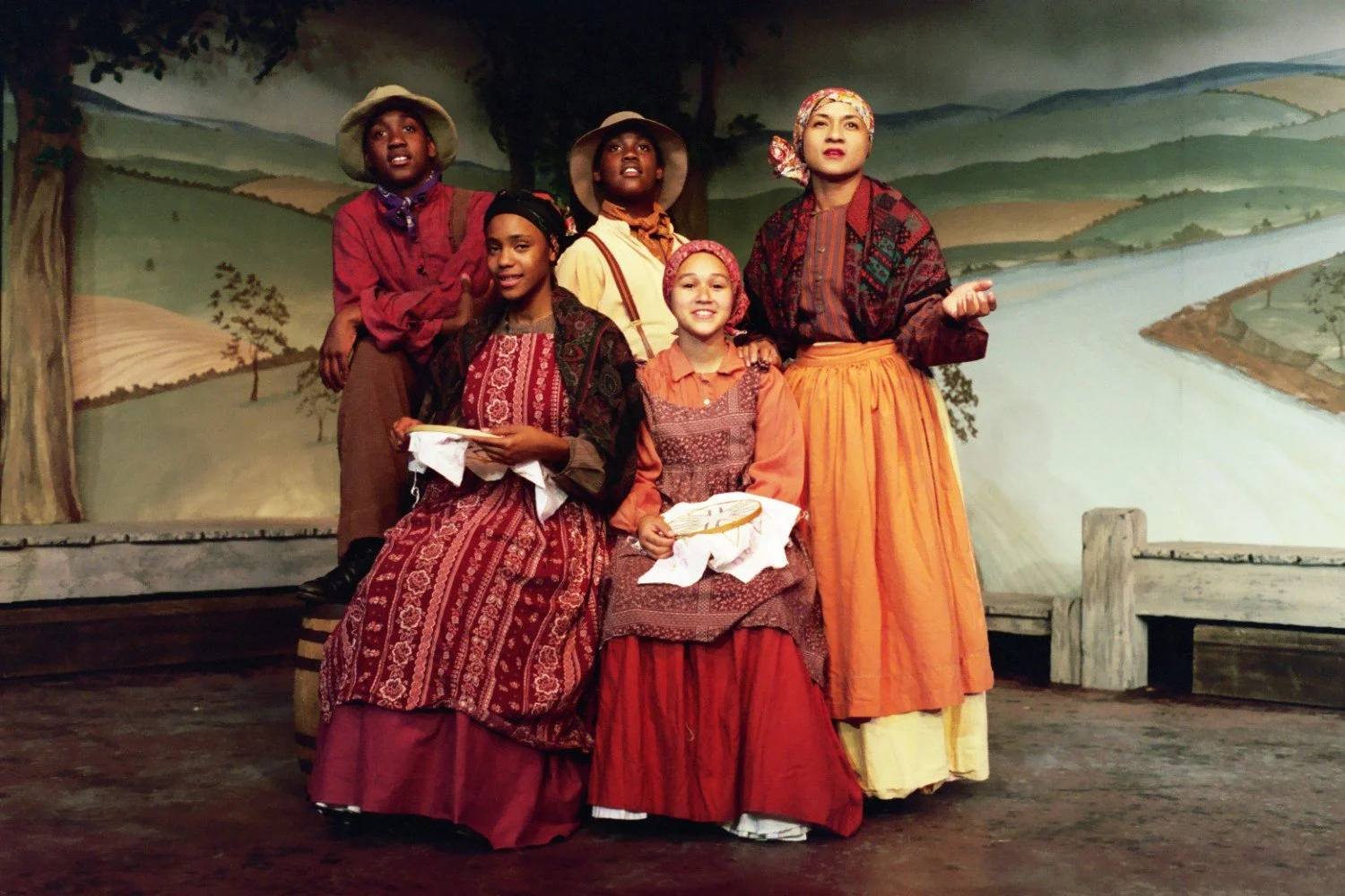 Group of people in vintage-style costumes on stage