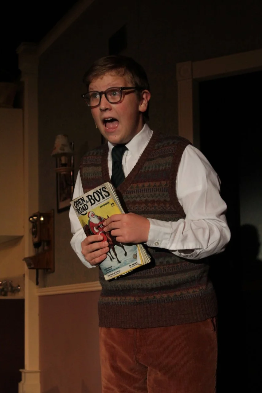 Young person in retro clothing holding a vintage magazine indoors.