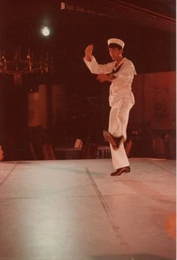 Person in sailor costume performing dance on stage