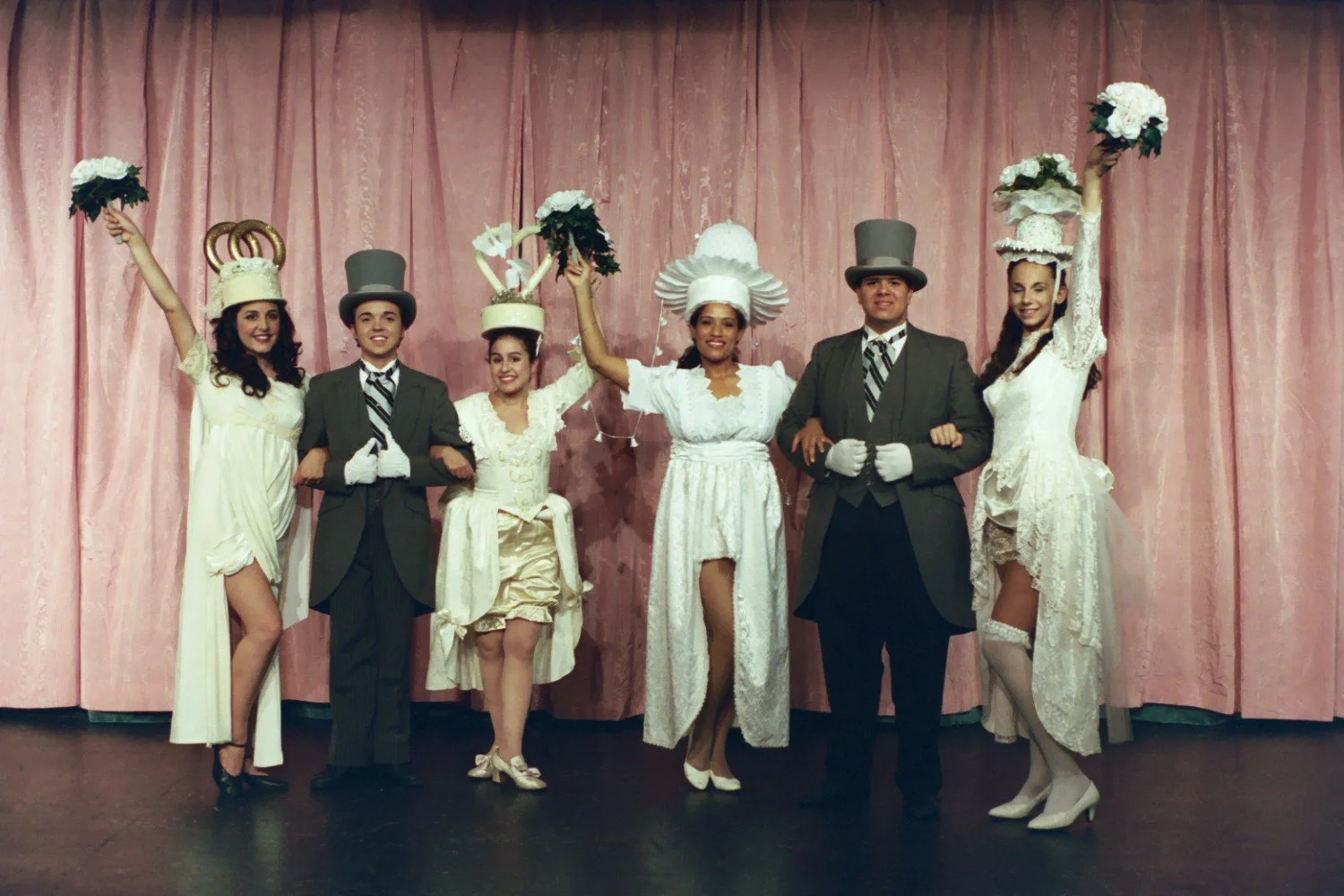 Group of performers in vintage costumes on stage