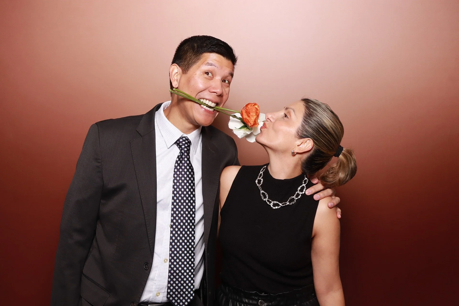  Couple posing together with props at the PACCO Gala photo booth in Portland 