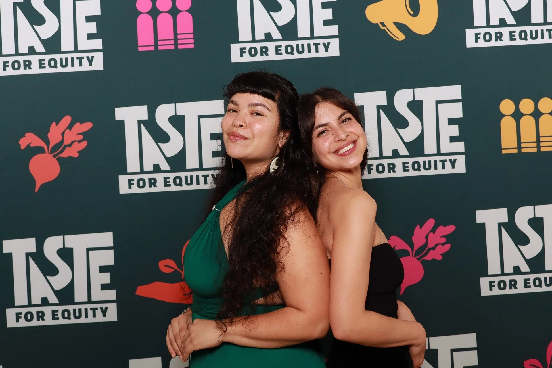 Friends back to back posing for a photo booth photo at a portland gala.