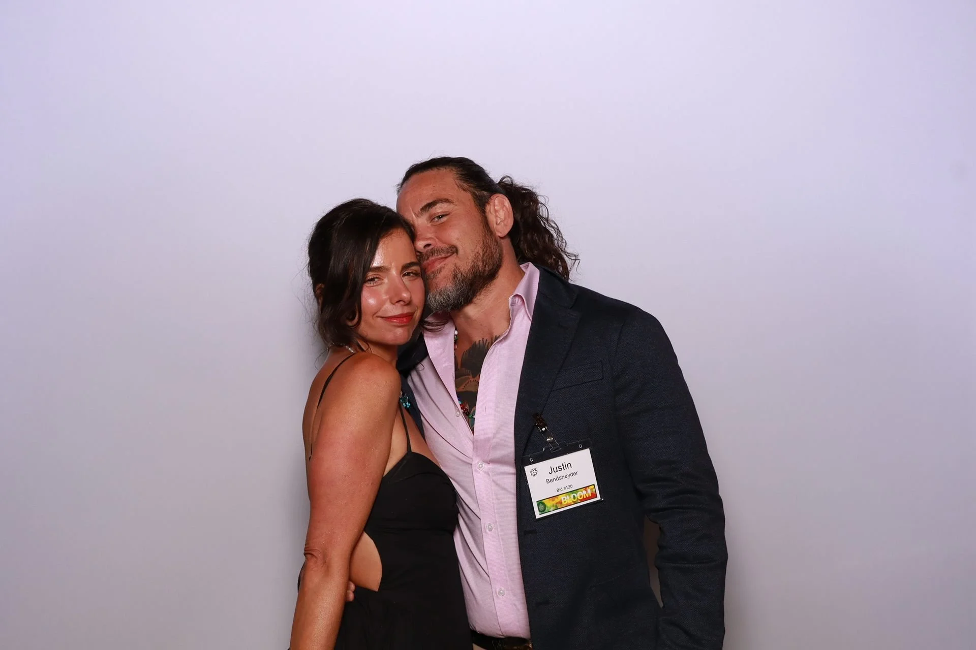 Nonprofit gala guests smiling together inside photo booth in Portland.