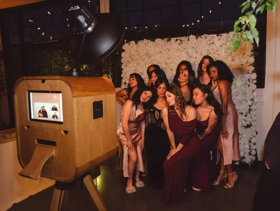 wedding party posing with bride for photo booth at castway venue in portland.