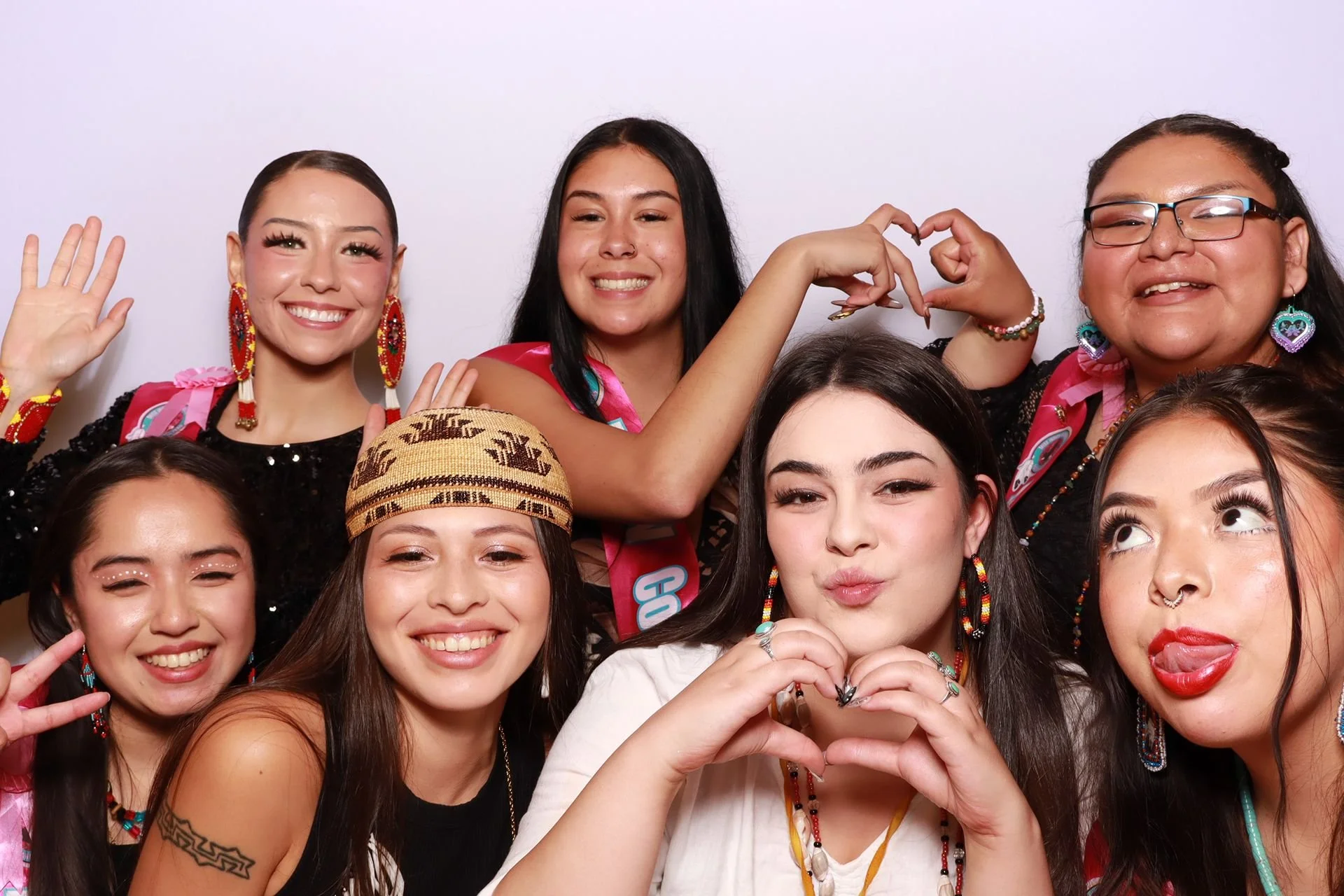 Luncheon guests smiling in a photobooth in Portland.