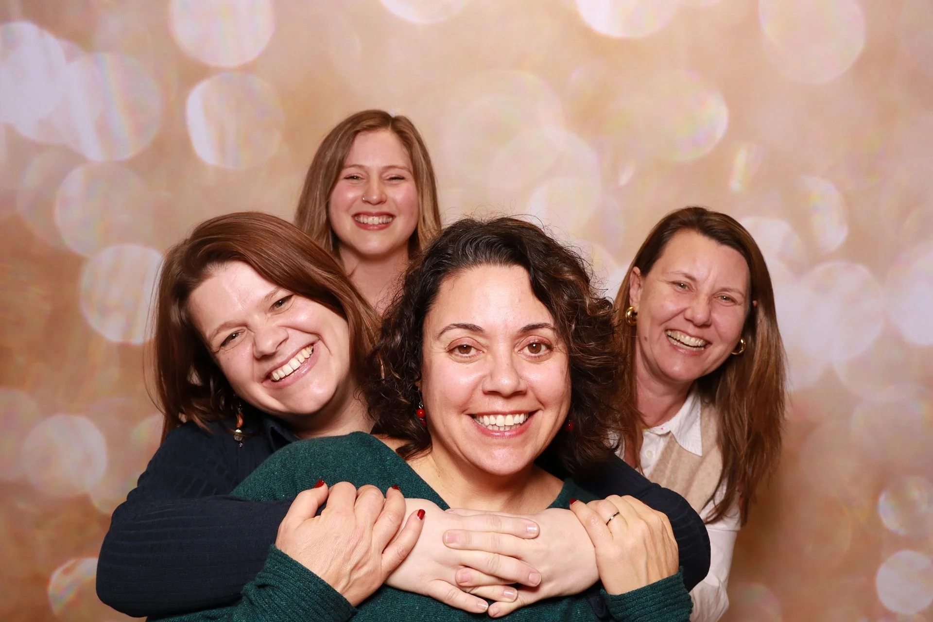 Friends enjoying a photo booth at a product launch in Portland.