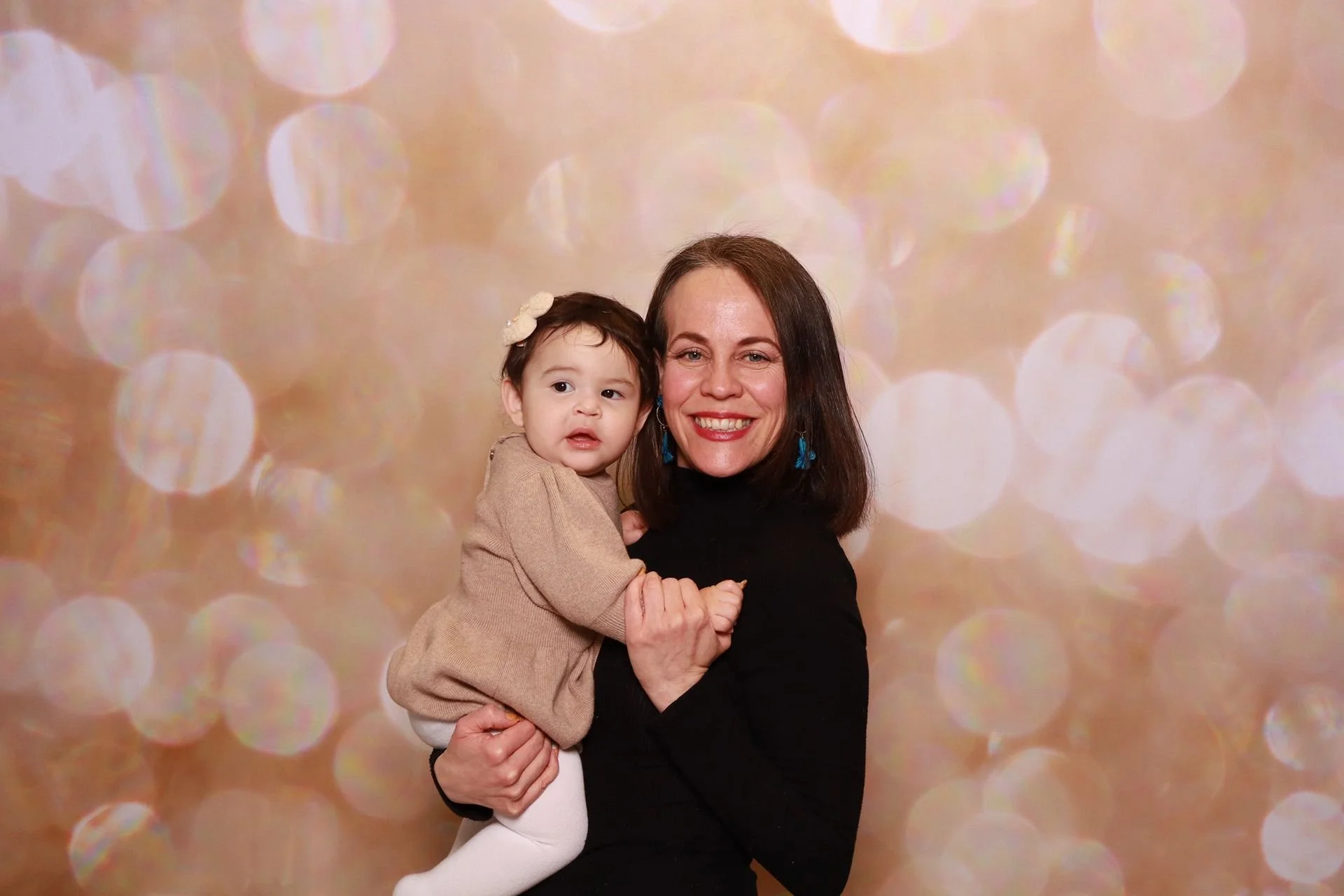 Mother and daughter posing in a photo booth at a product launch