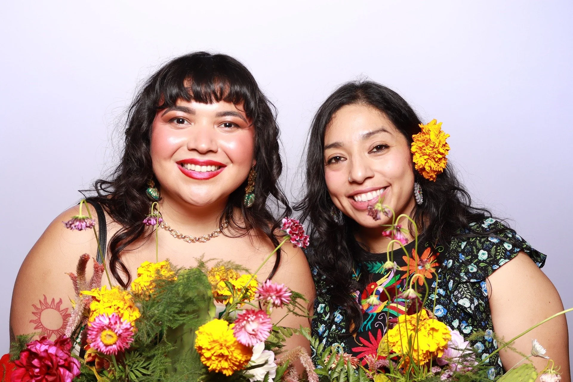 open-air-photobooth-duo-holding-flowers.jpg