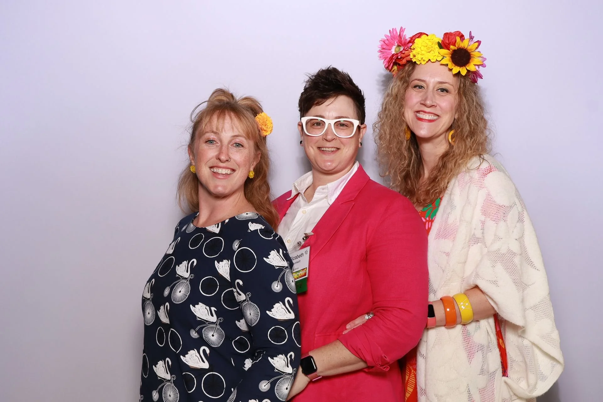 Three friends enjoying the photo booth at a gala in Portland Oregon.