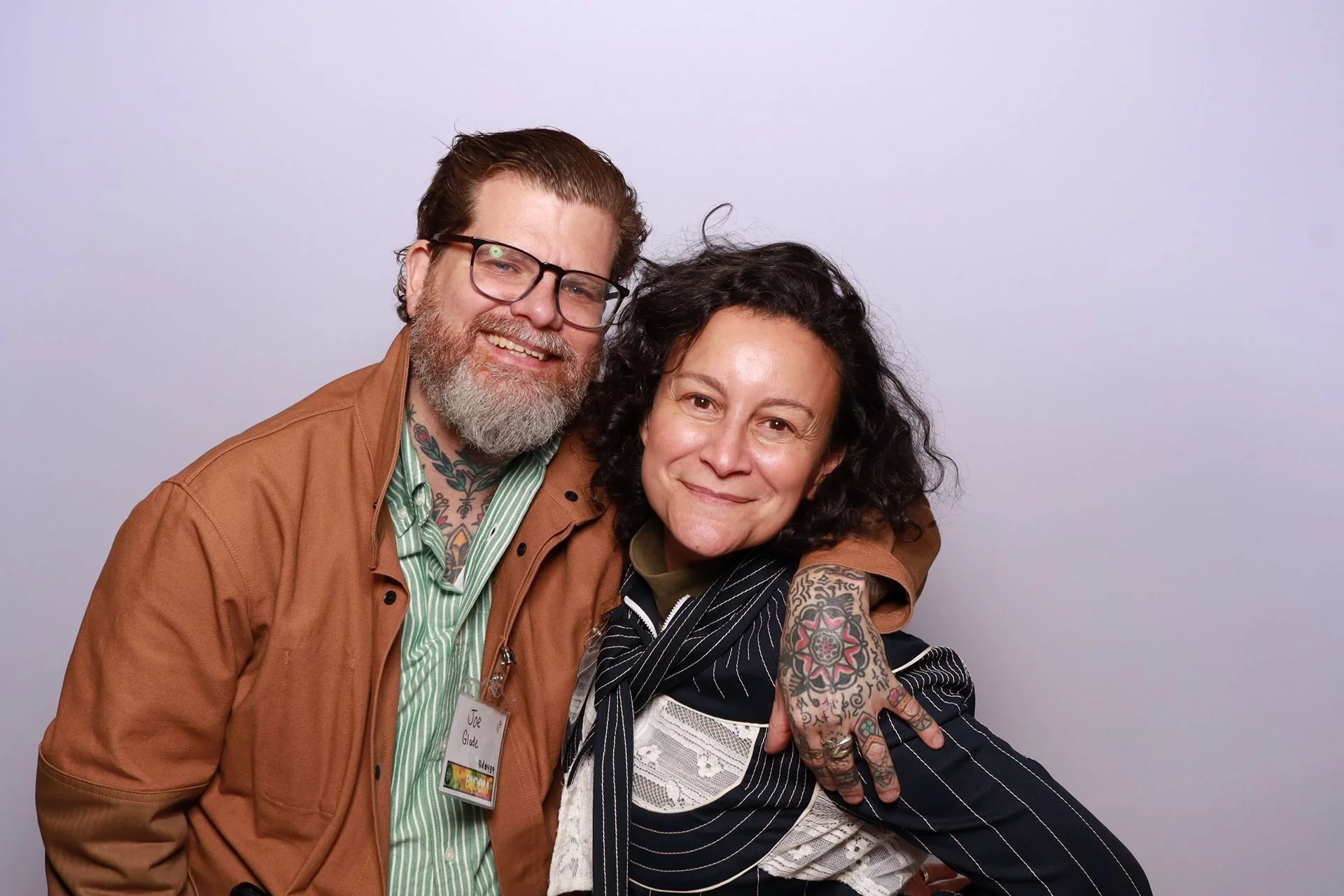 Husband and wife posing in a photo booth at a gala in Portland Oregon.