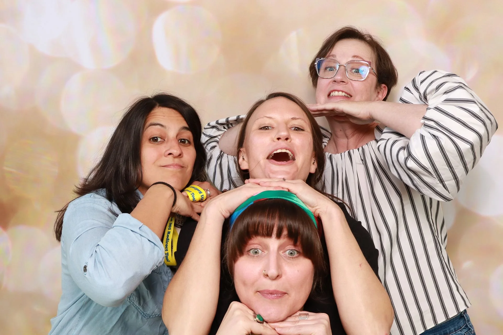 Colleagues posing for photo booth at a festival in Portland.