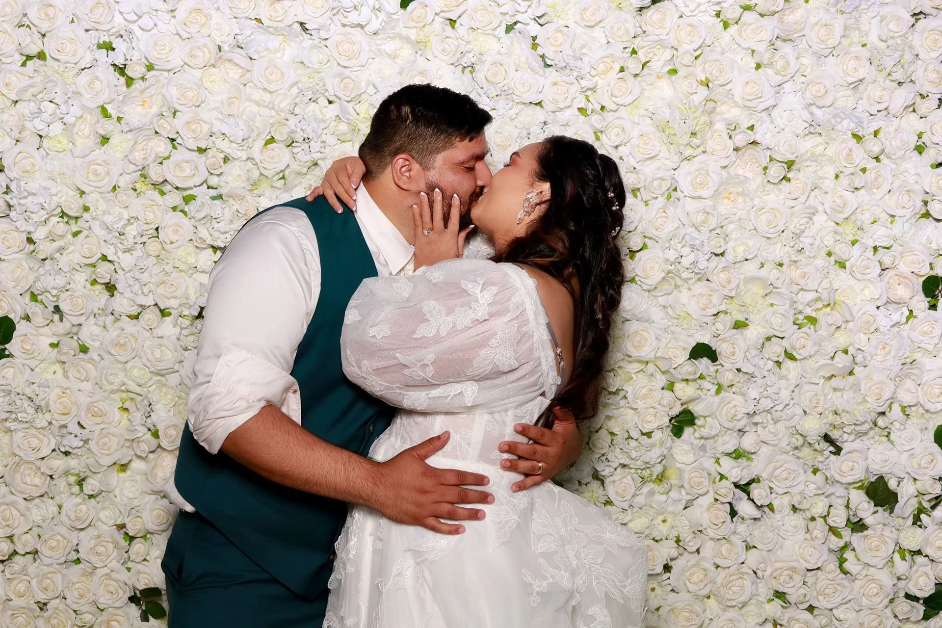 Brie and the groom kissing in a photobooth Alsea Oregon.