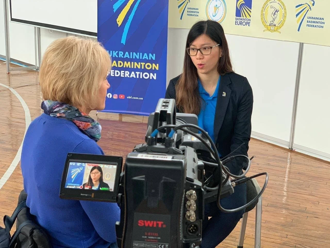 Taniah Teoh being interviewed at a badminton event