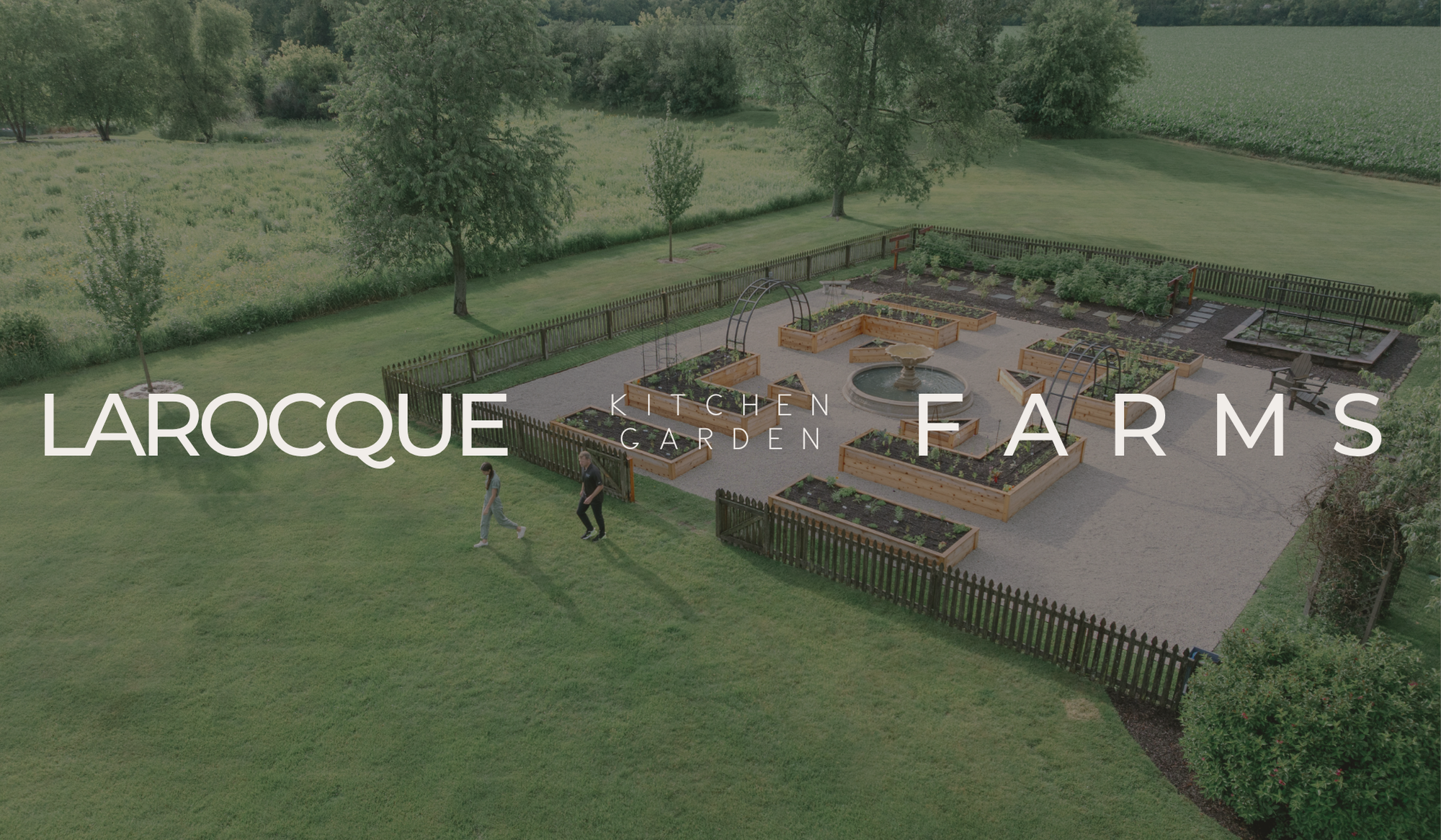 Aerial view of the LaRocque Farms kitchen garden showing its symmetrical potager layout, central fountain, cedar raised beds, and surrounding countryside.