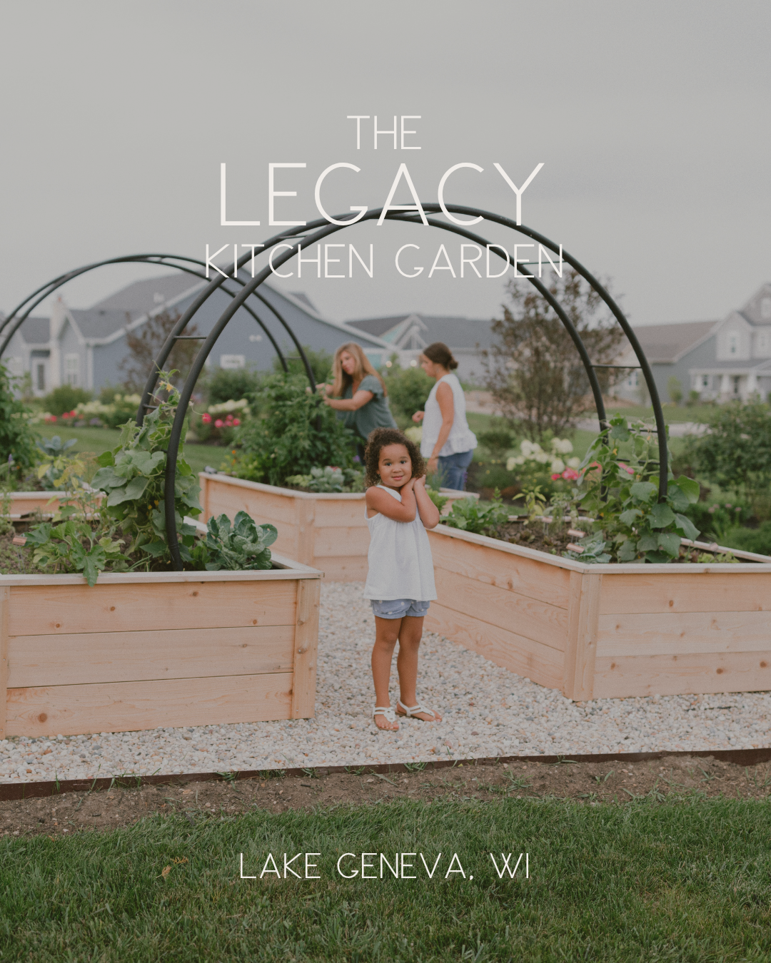 The Legacy Kitchen Garden in Lake Geneva, Wisconsin, with cedar raised beds, custom black arch trellises, and three generations enjoying the garden.