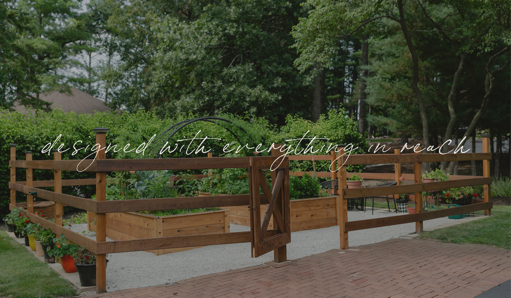 The Hawks Garden with cedar raised beds, a fenced entrance, and built-in features, designed with everything in reach.