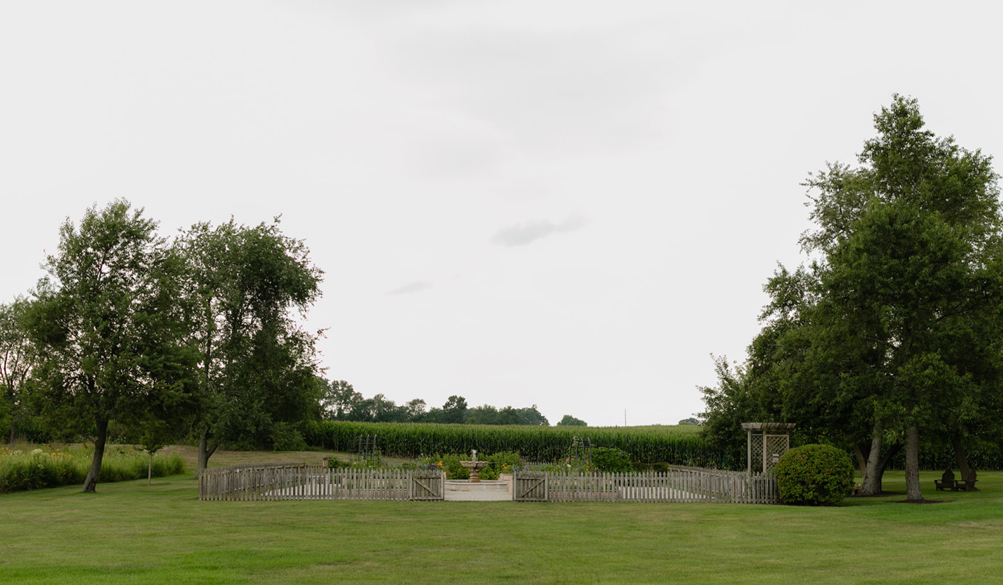 LaRocque Farms kitchen garden set within the secluded countryside, surrounded by mature trees, lawn, and farmland in Walworth, Wisconsin.