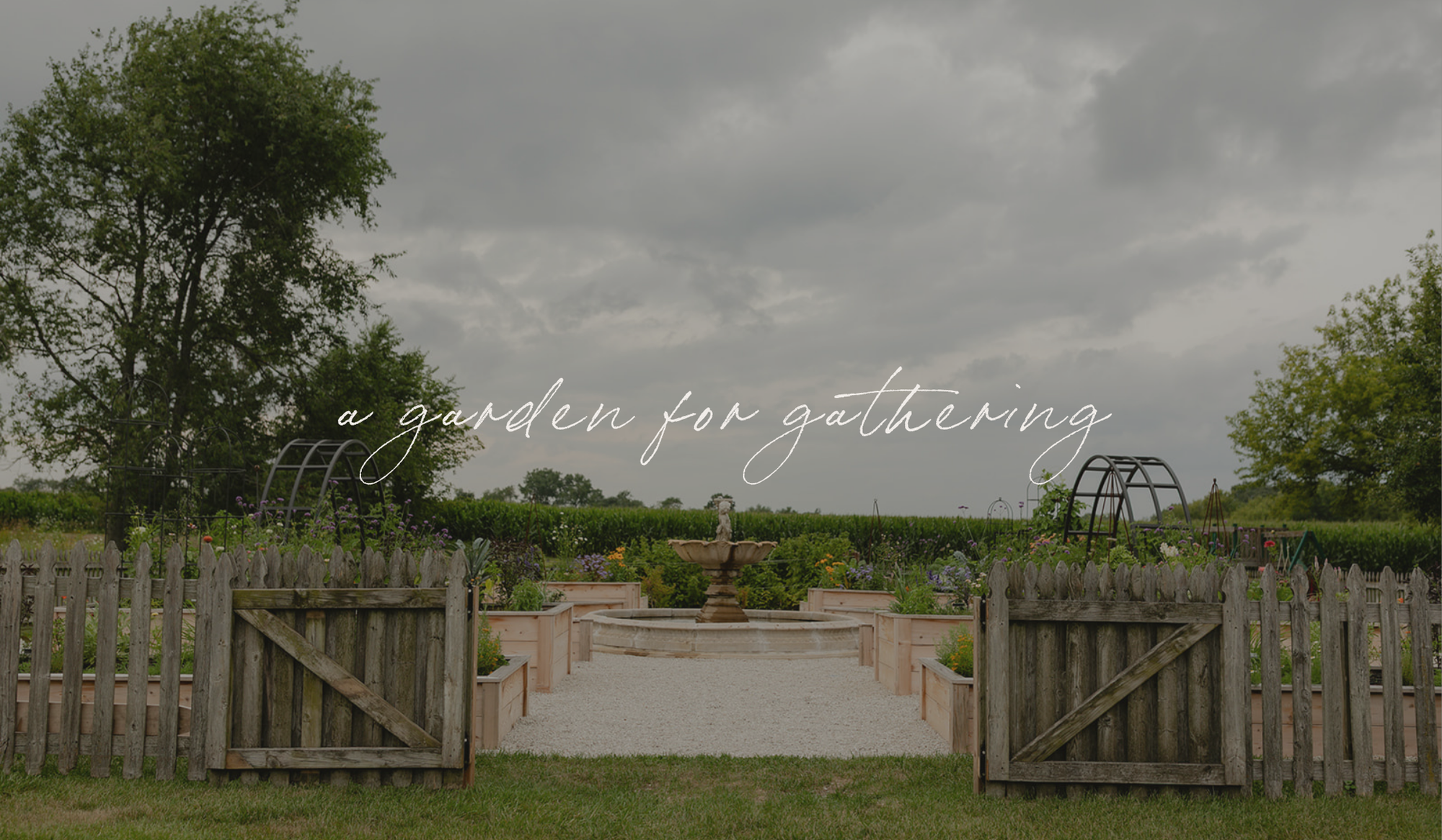 Open gates welcoming guests into the LaRocque Farms kitchen garden beneath the words “a garden for gathering.”
