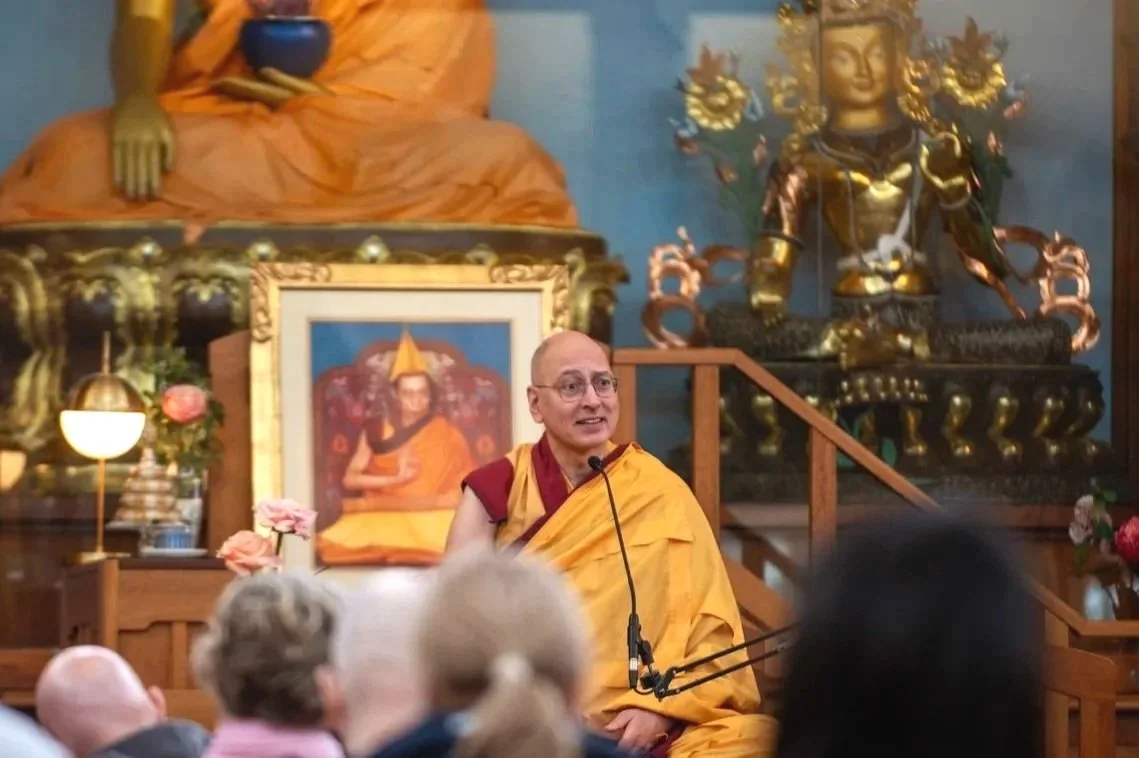 Buddhist monk, Gen Samten, teaching on a throne to an audience