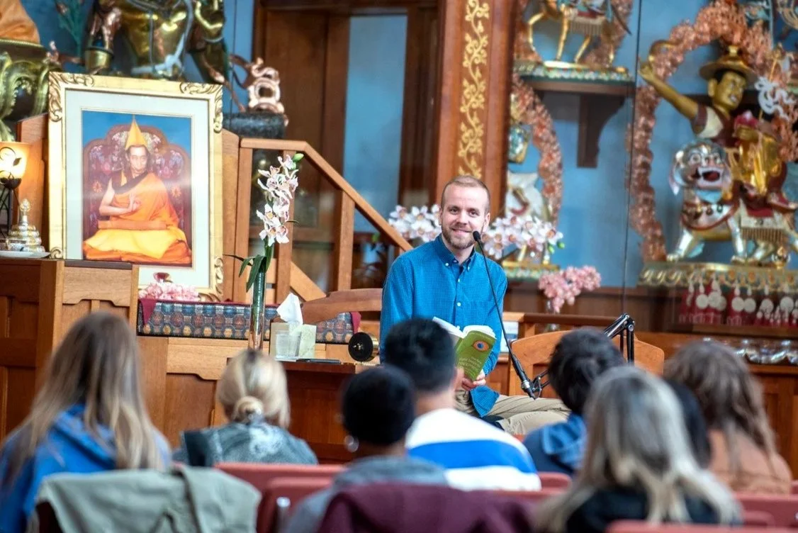 Buddhist teacher, Kadam Kyle Davis, teaching a meditation class to an audience