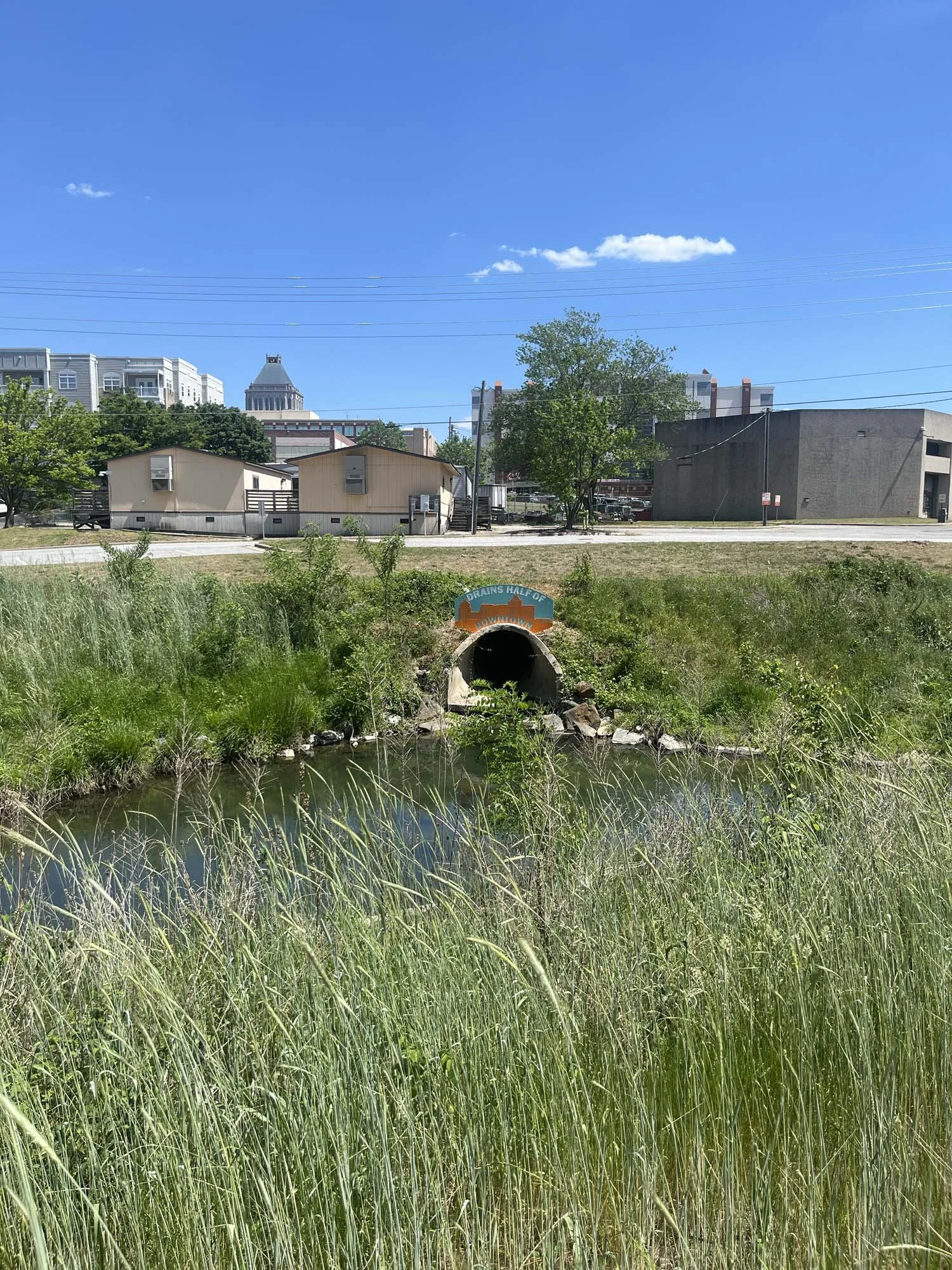 "Drains Half of Downtown" sign above the creek's drain