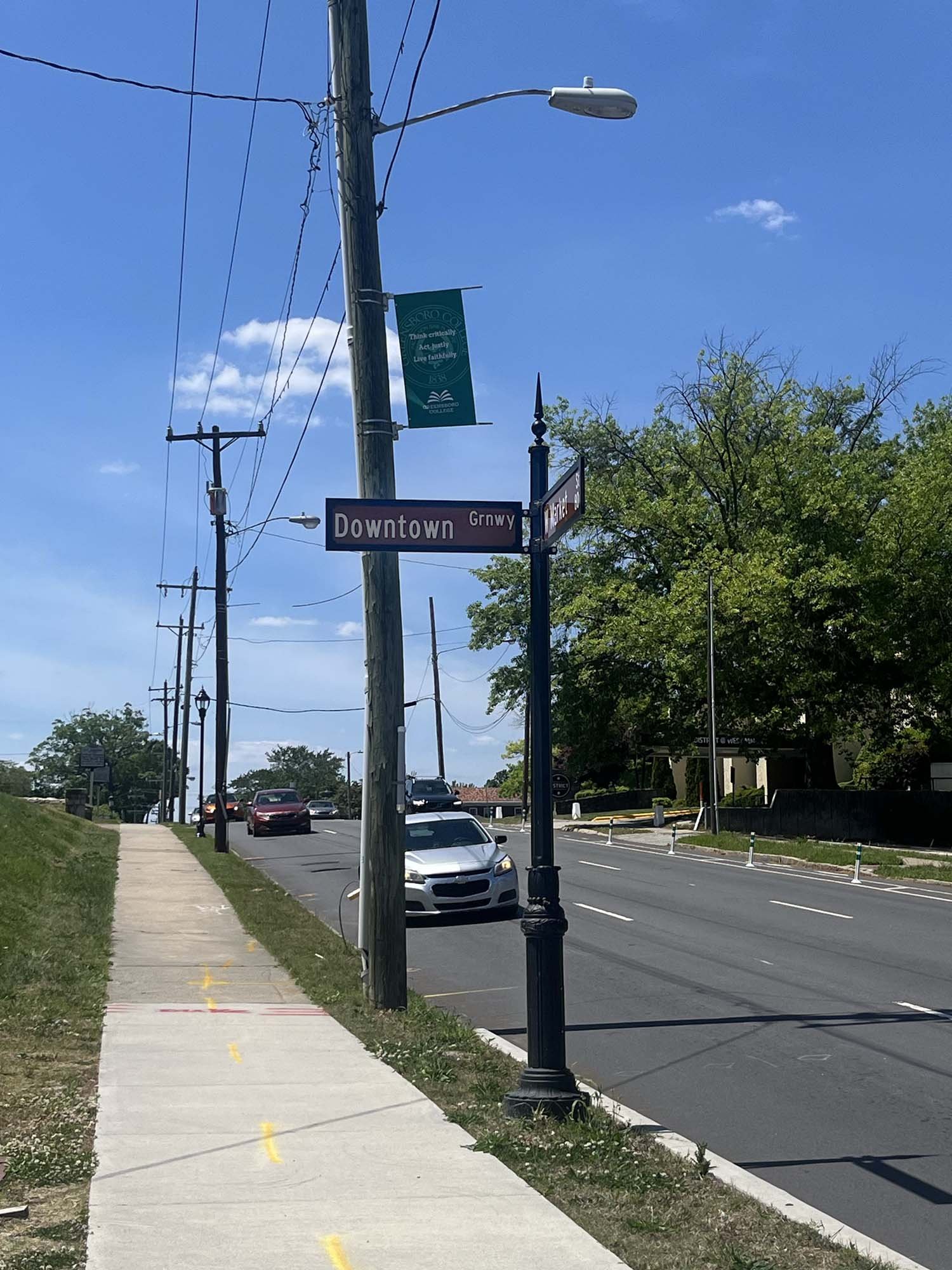 Downtown Greenway road sign at W Market St crosswalk