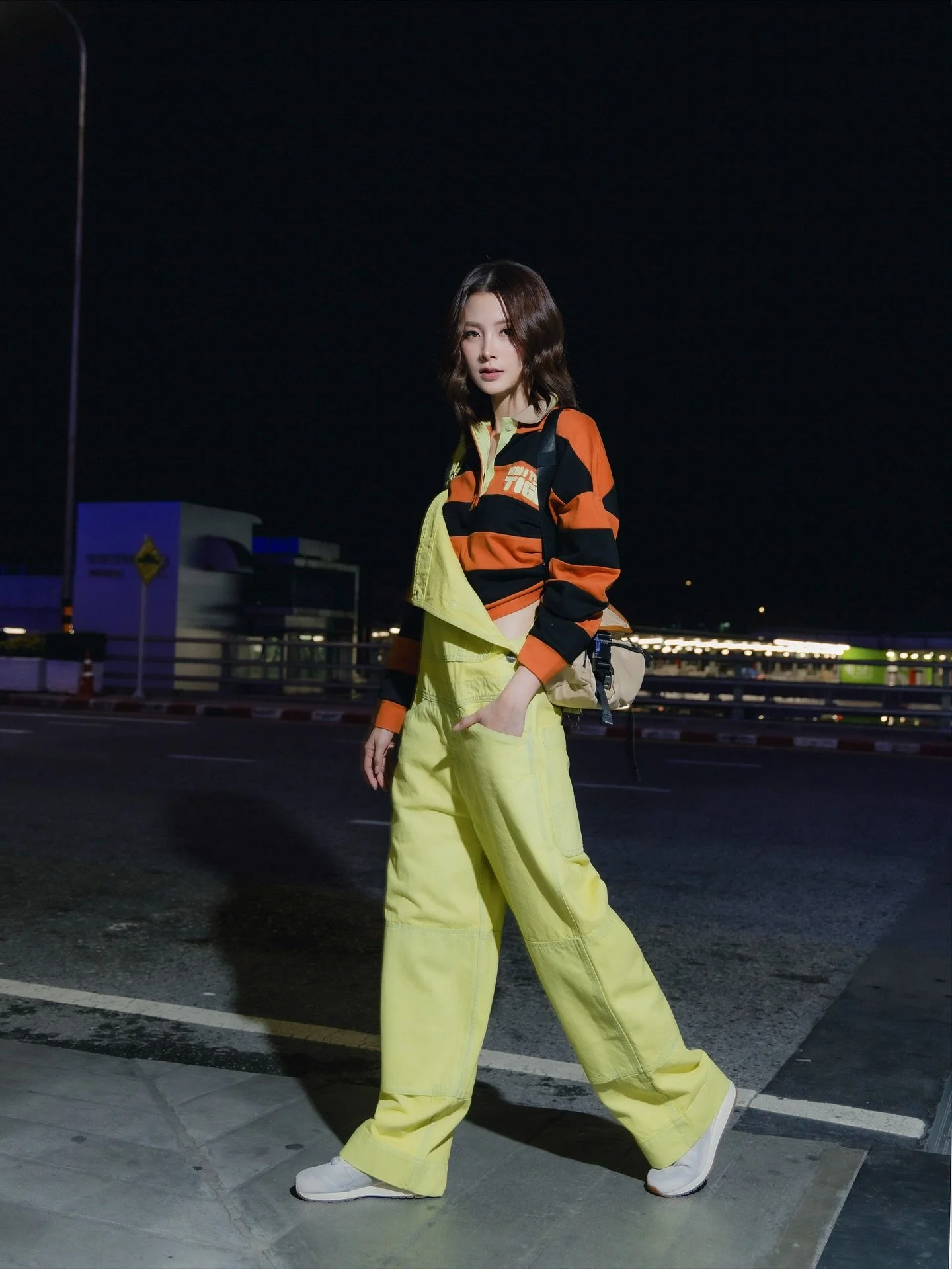 Hael Husaini, Baifern Pimchanok and Ayden Sng pose in Onitsuka Tiger at the airport as they make their way to Milan for the Onitsuka Tiger Spring/Summer 2026 Milan Fashion Show. 

Fit deets: 
&bull; Hael Husaini in OVERSIZED POLO SHIRT, PANTS, CAP, M