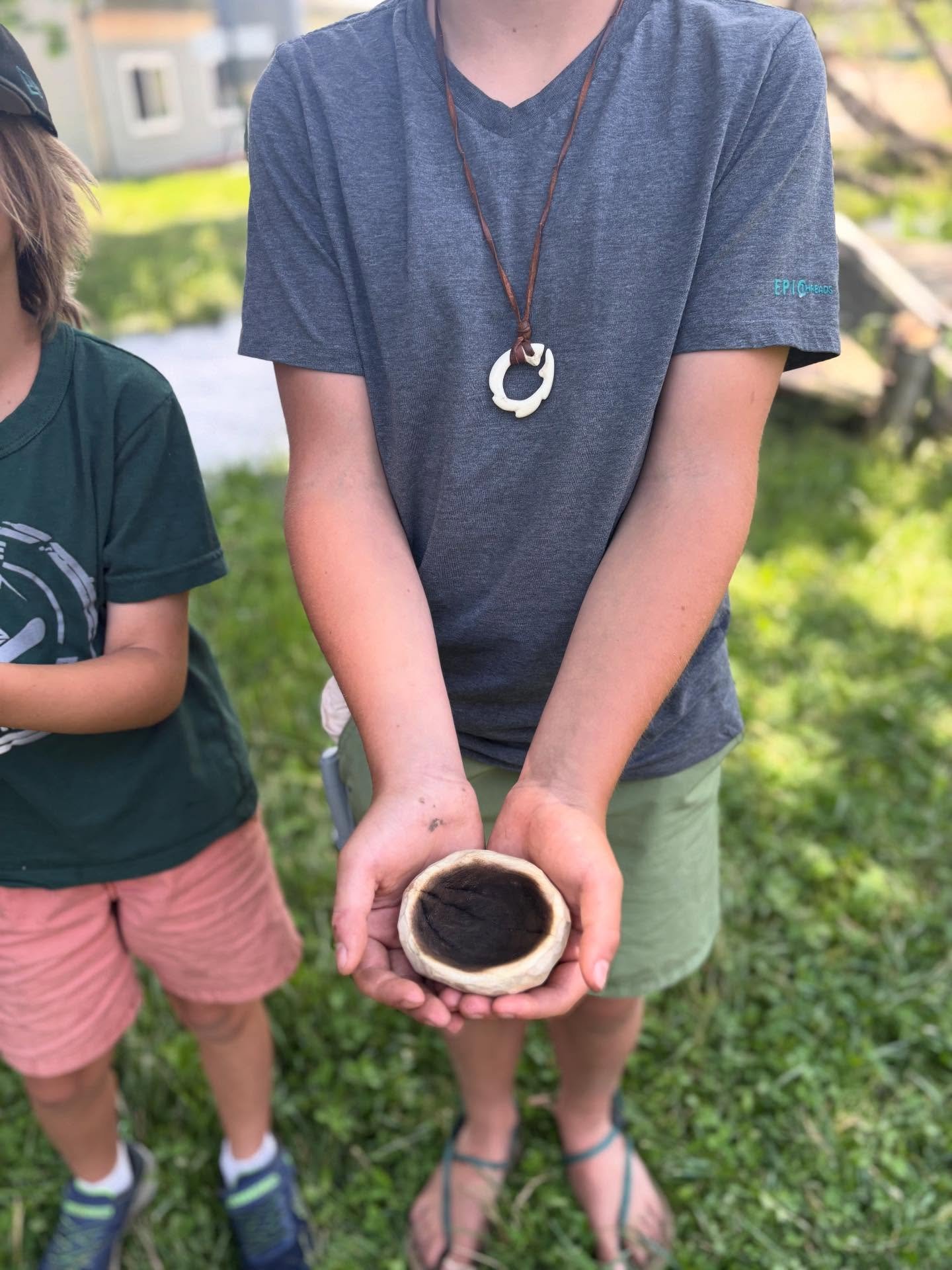 Coal burned bowls. We had a very cool rainy spring and so were able to have lots of fires. Coal burned bowls are one of my favorite projects for children because they get to know qualities of different kinds of wood (I have several available to choos