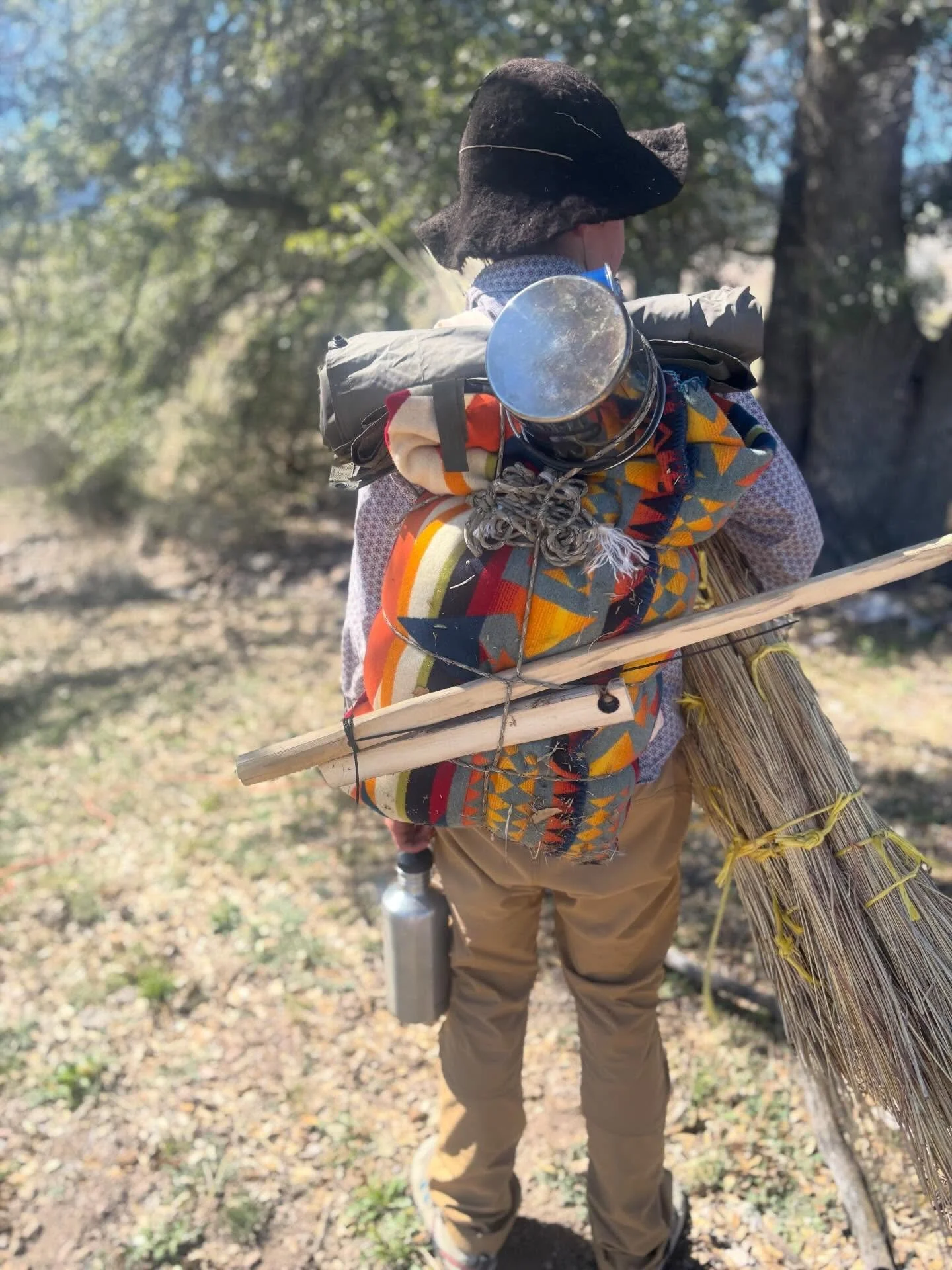 Blanket pack.  I learned this trick on my BOSS expedition- how to perfectly roll up the wool blanket to carry all of your gear.  Here is River, ready to head out for an overnight by himself on the land with blanket pack tied up.