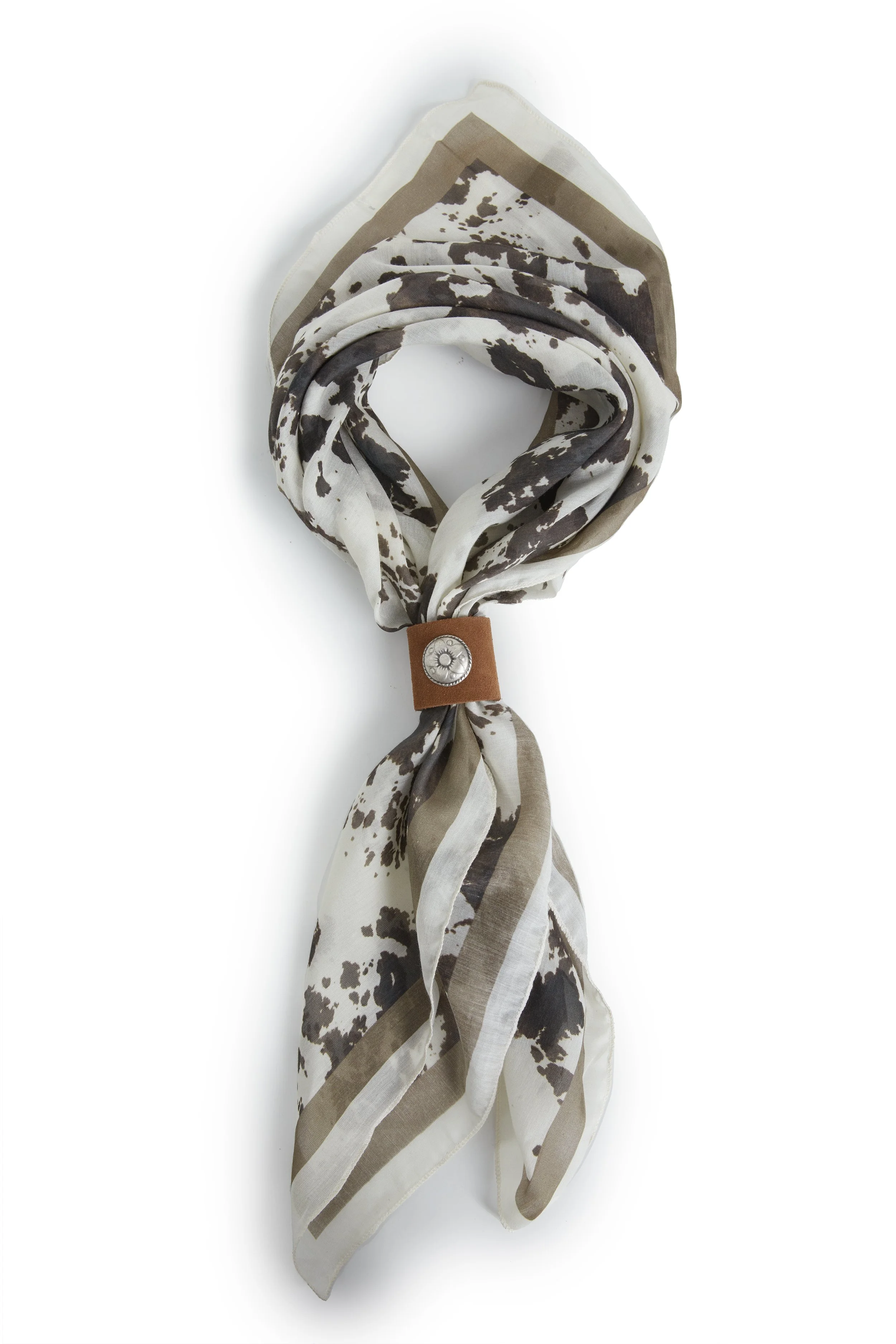 A scarf with a cow print pattern in black, white, and beige colors, tied in a knot with a brown leather strap and a metallic button.
