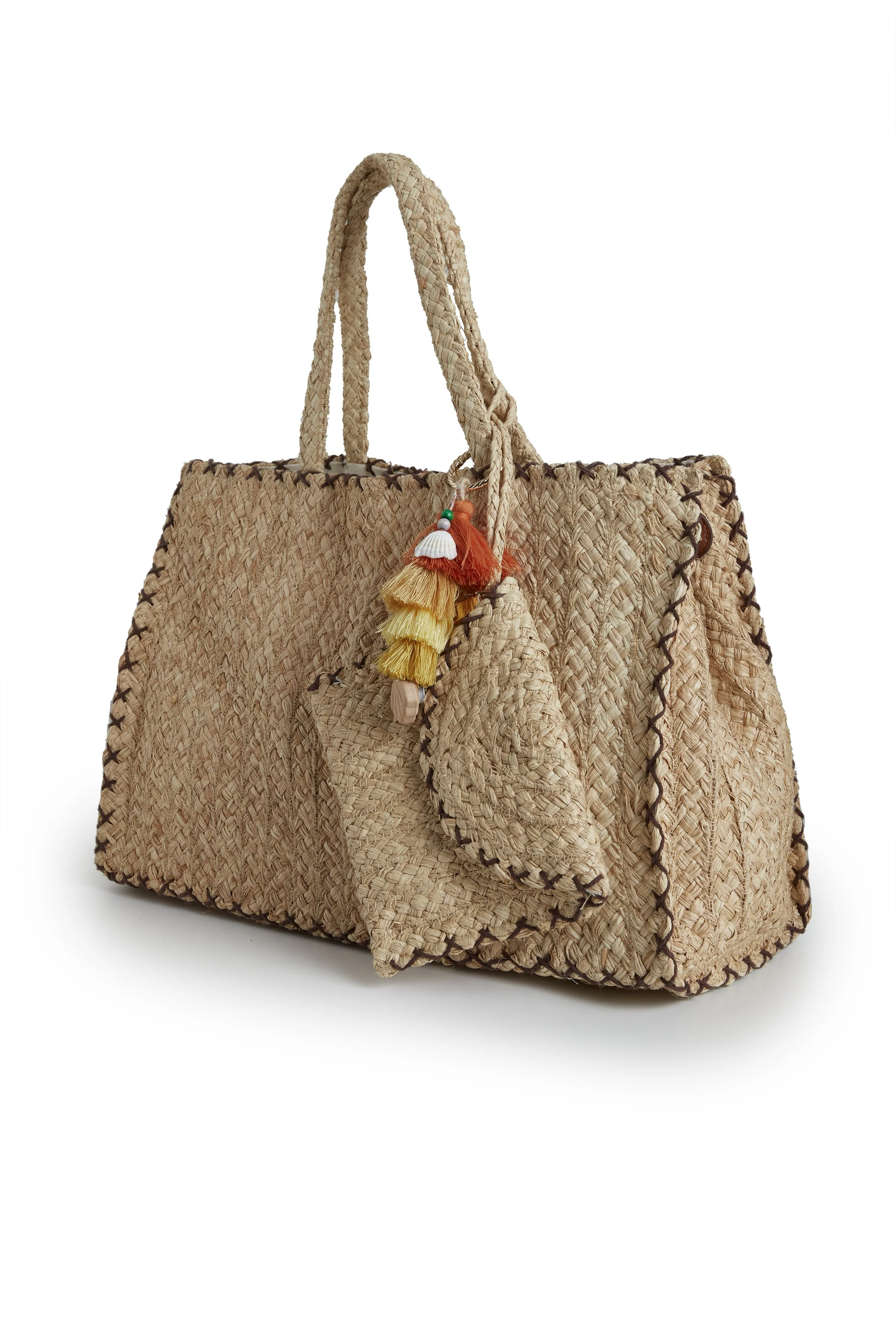A large woven straw tote bag with matching smaller straw bags hanging from its handle, decorated with colorful tassels.
