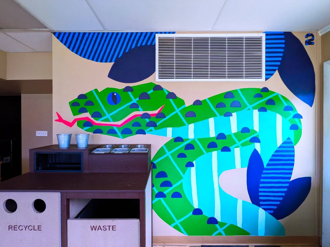 Sumatran Pit Viper mural in the Jungle Grill Building at the Racine Zoo, showing a colorful jungle snake and leaves with dots and stripes cropped to show fit on wall.