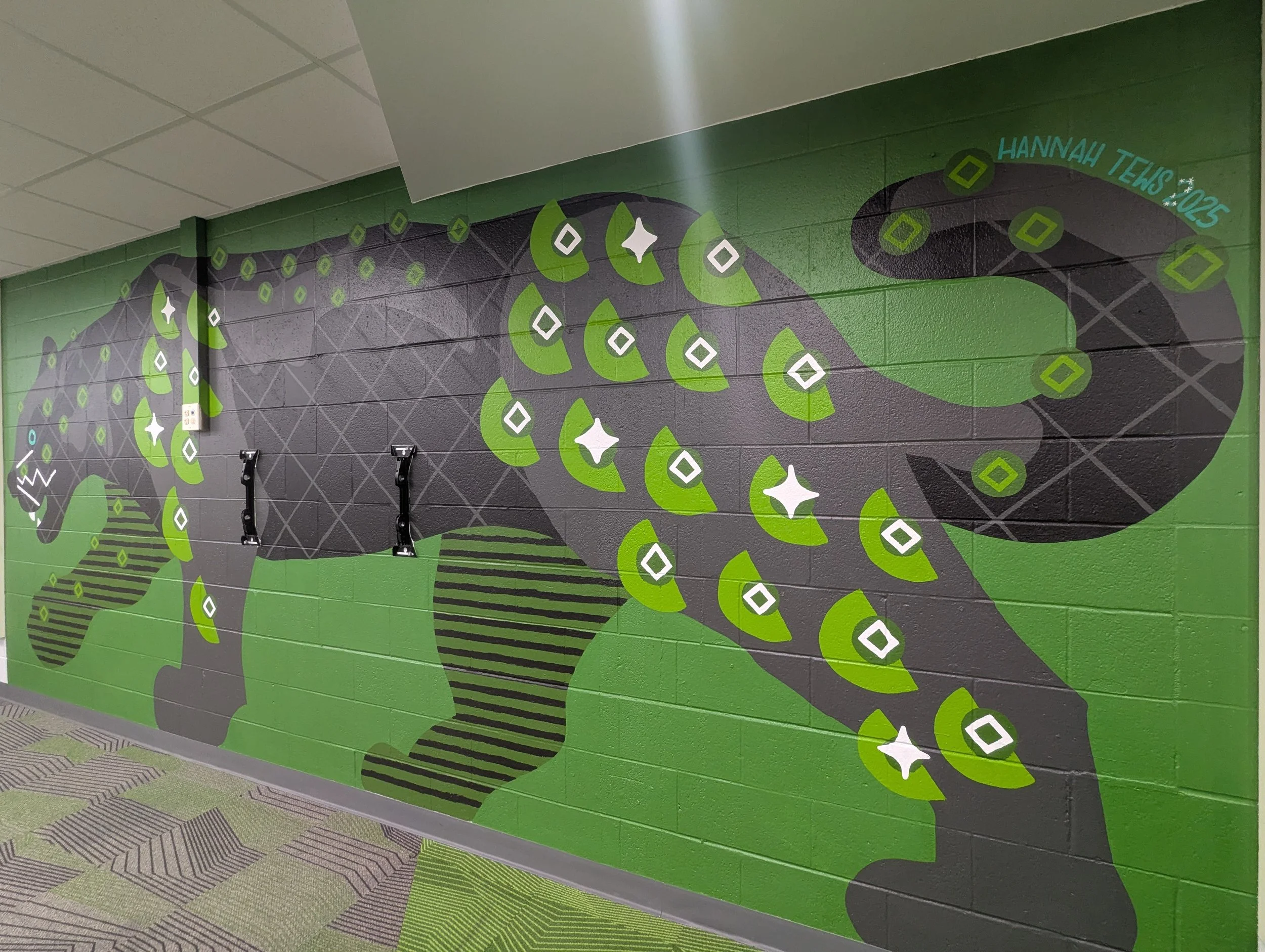 Angled full-body shot of the black panther elementary school mural viewed from the tail end.