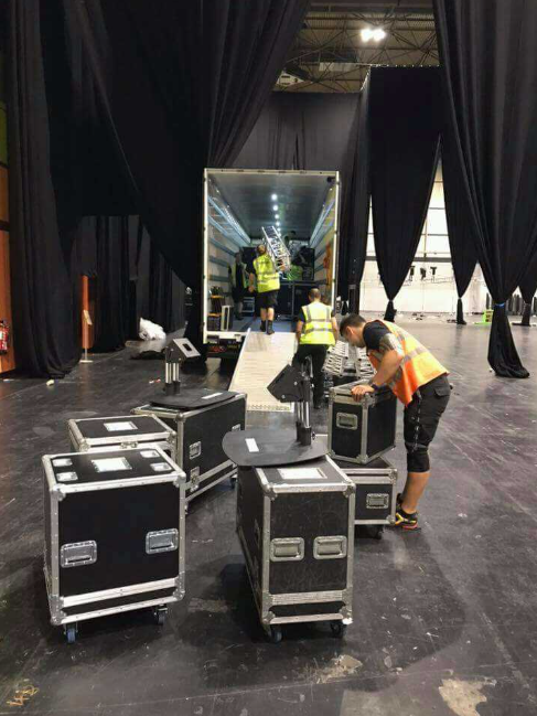 Stagehands loading gear into a truck