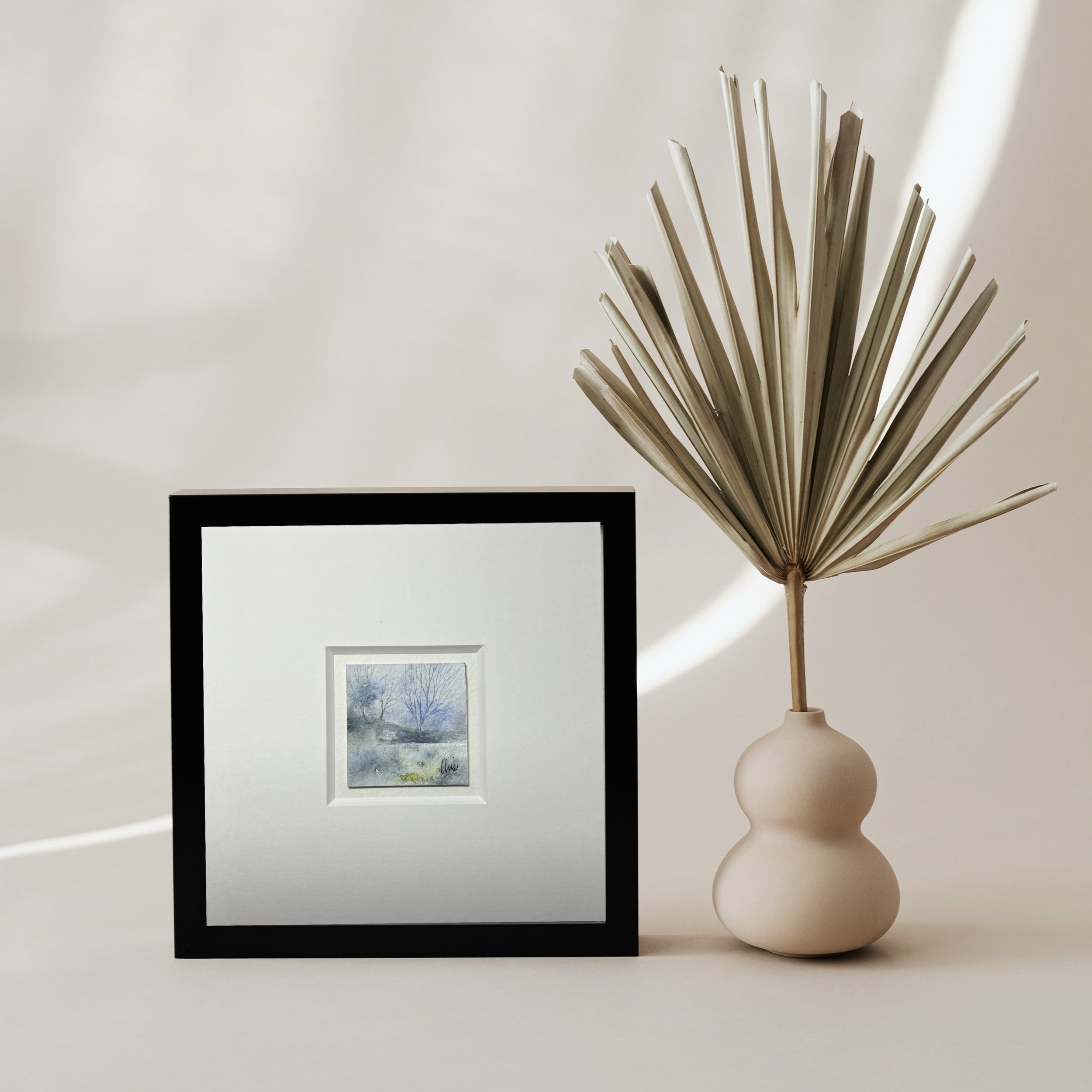 Lakeside miniature painting, black frame with plant