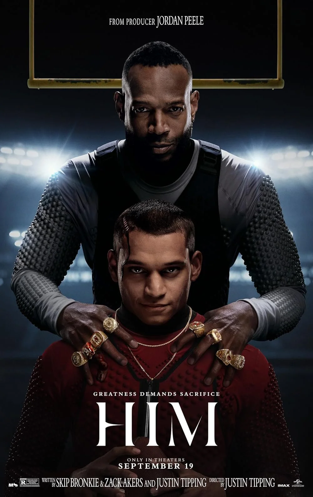 Movie poster for 'HIM' depicting two men, one standing behind the other, with intense expressions. The man in front is dressed in a red jacket with gold jewelry, while the man behind wears a black sports top and has his hands on the other's shoulders