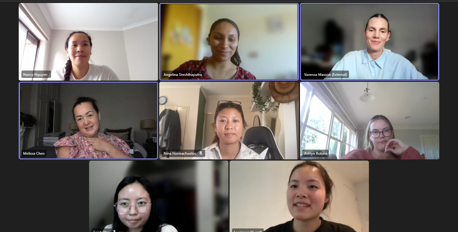 Screenshot of a virtual meeting with nine women in a grid layout, each in their own space, appearing engaged and smiling.