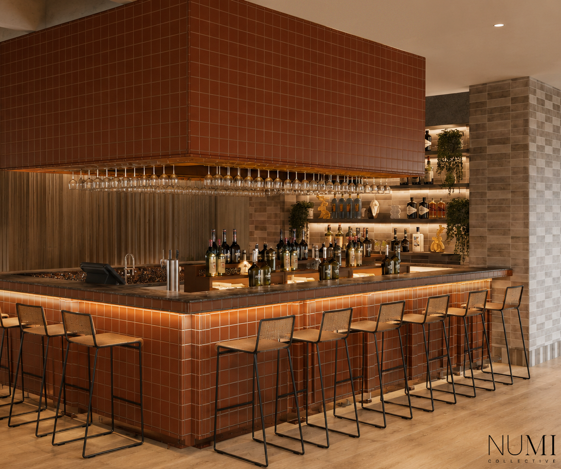 Modern bar with brown tiled counter, wine bottles, hanging wine glasses, and shelves with decorative items and greenery.