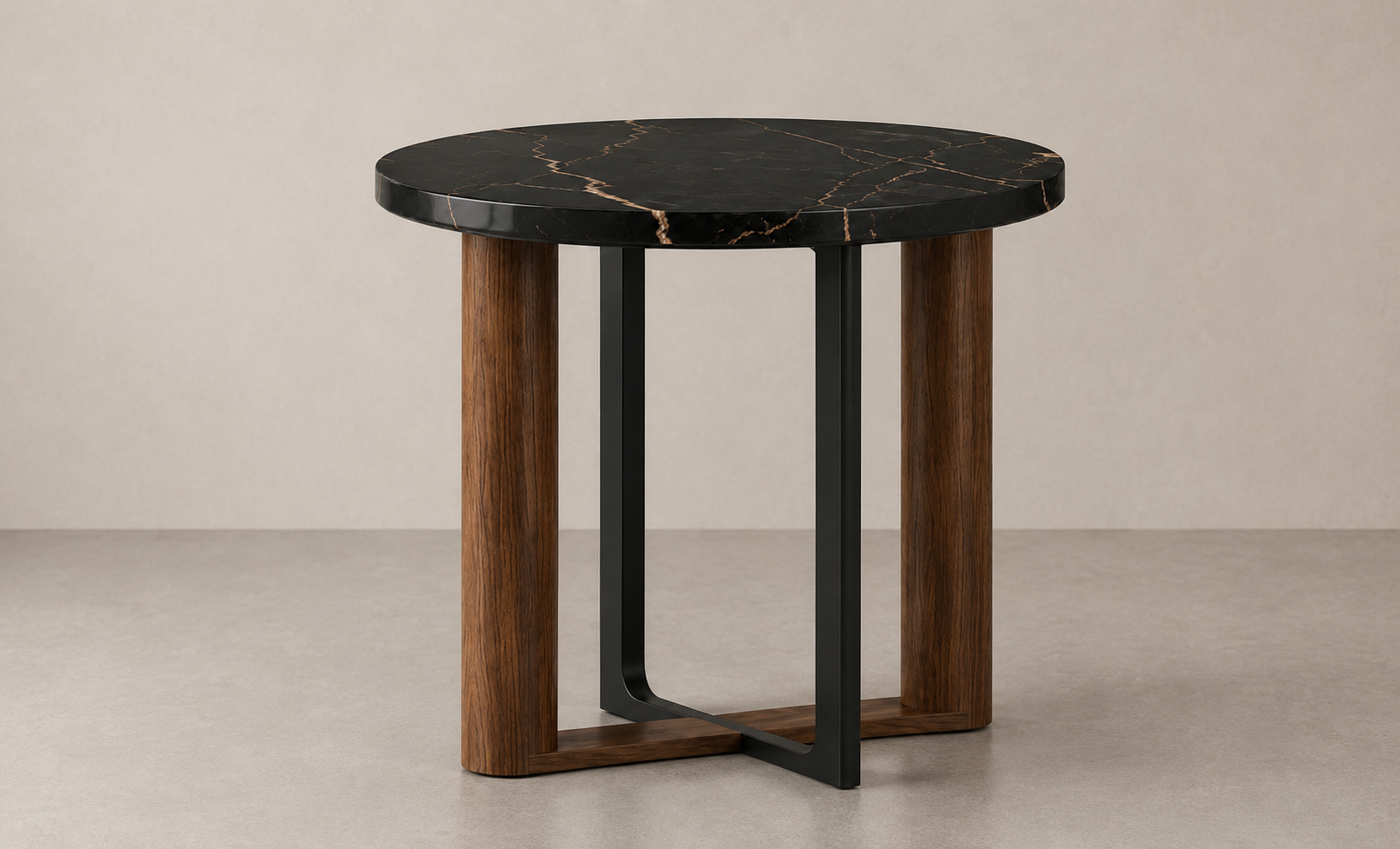 A modern side table with a round black marble top and a combination of wooden and black metal legs.