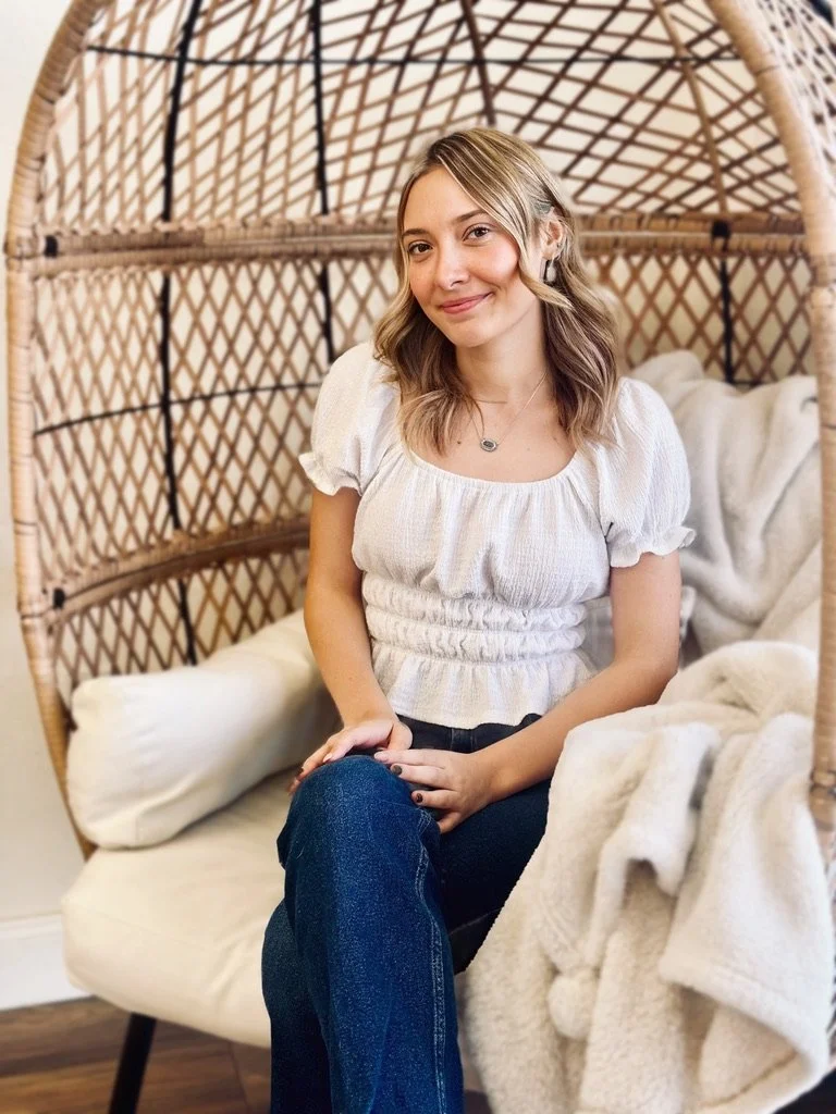 Blonde hair stylist sitting in a salon styling chair.