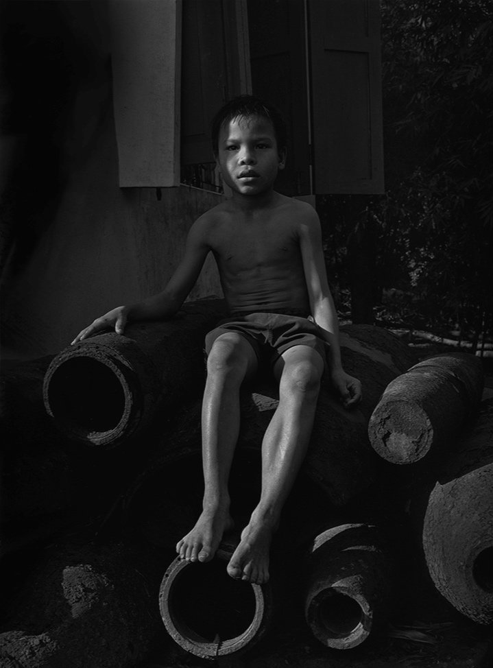 Boy Sitting On Ordence, Khe Sanh, Quảng Tri Province, Viet Nam | 2000 - 2005