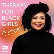 A woman with curly hair smiling, with a pink and black background that reads 'Therapy for Black Girls, the podcast,' and an iHeartRadio logo.
