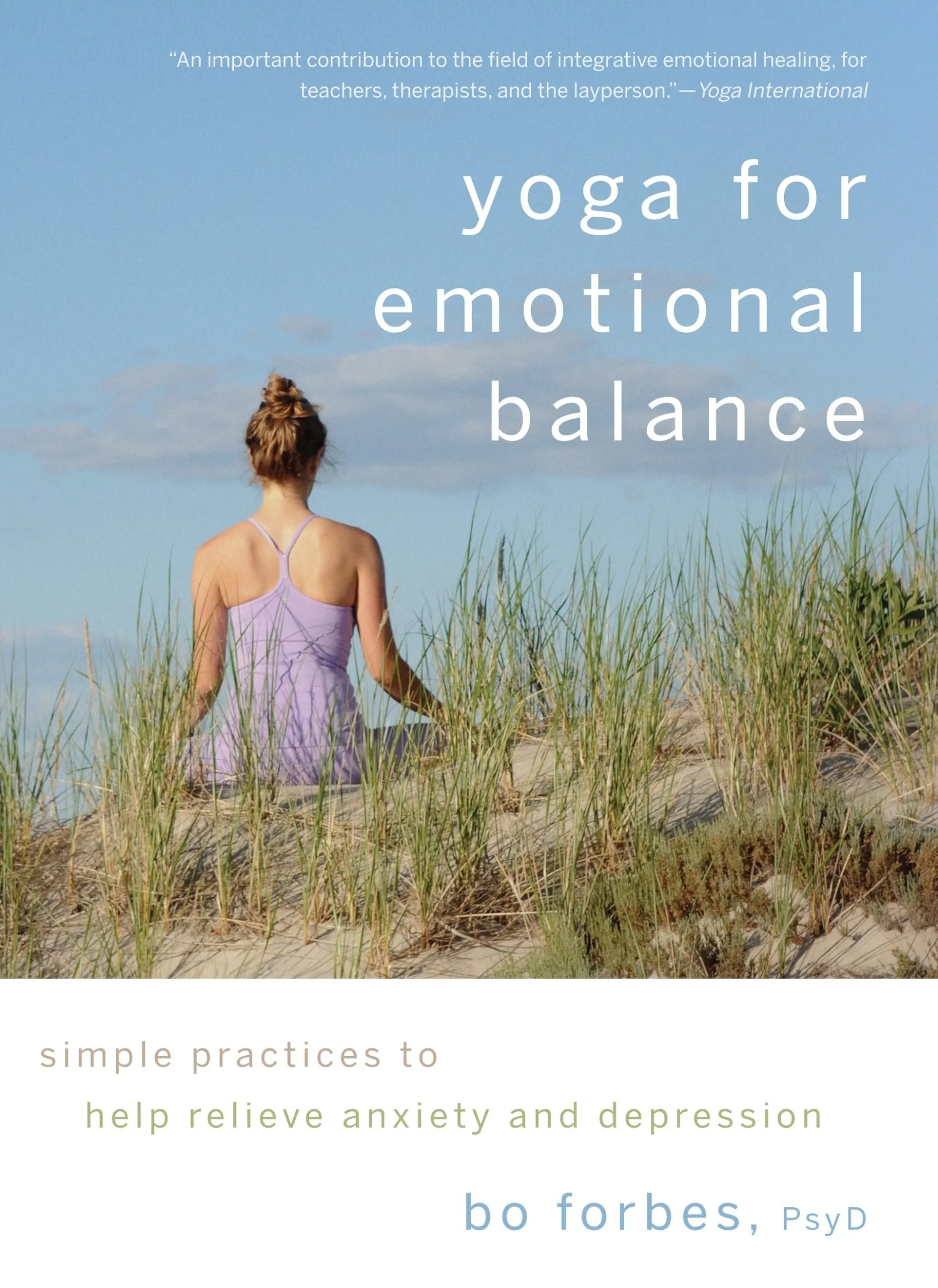 Book cover titled 'Yoga for Emotional Balance' by Bo Forbes, Psyd. Features a woman sitting on a sand dune amid tall grass, facing away, with a blue sky and clouds in the background.