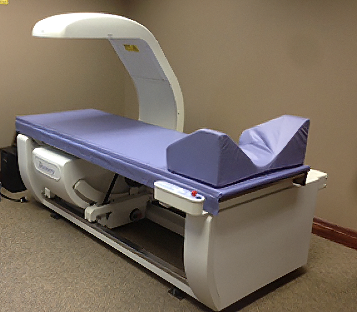 Medical imaging machine, possibly an MRI or CT scan device, in a clinical setting.