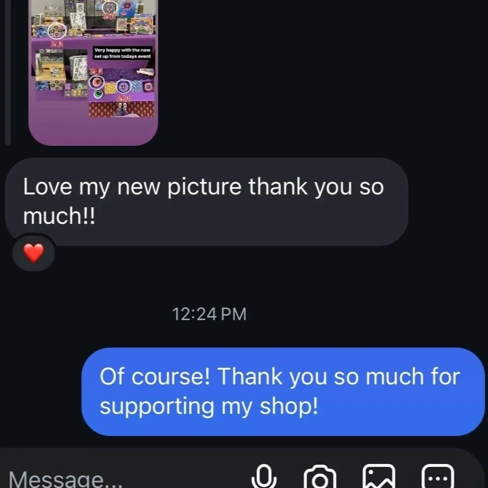 Screenshot of a chat conversation showing a message with a photo of a colorful display, likely a craft or art setup, and text expressing happiness with a new picture and gratitude for support.