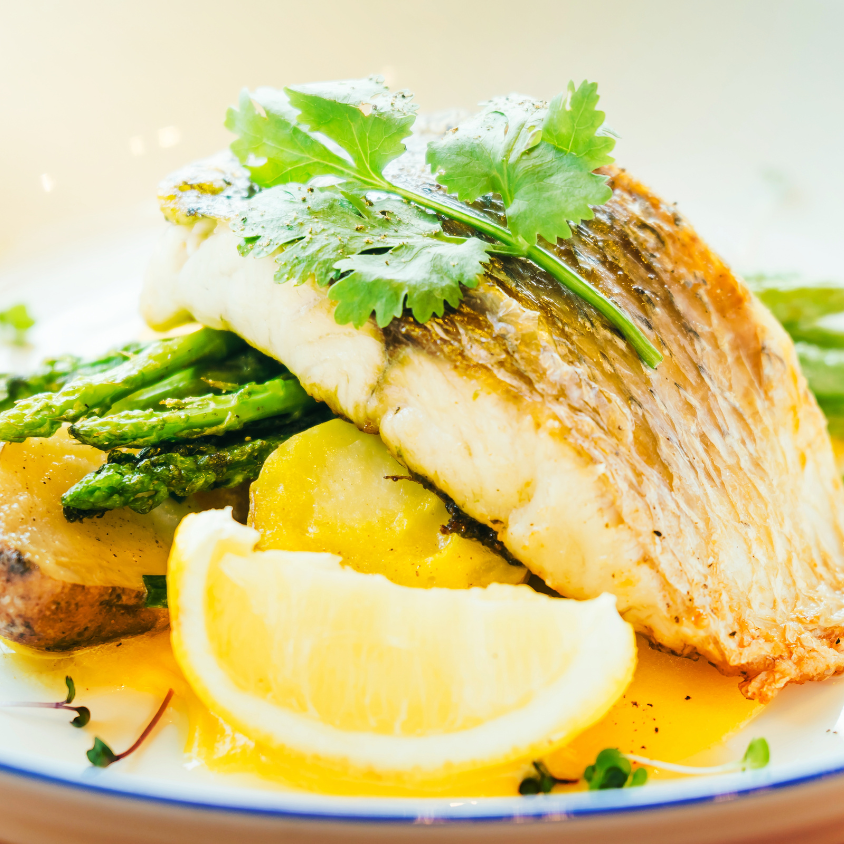 Herb crusted barramundi, lemon butter sauce, baked leek and baby potatoes (gf)