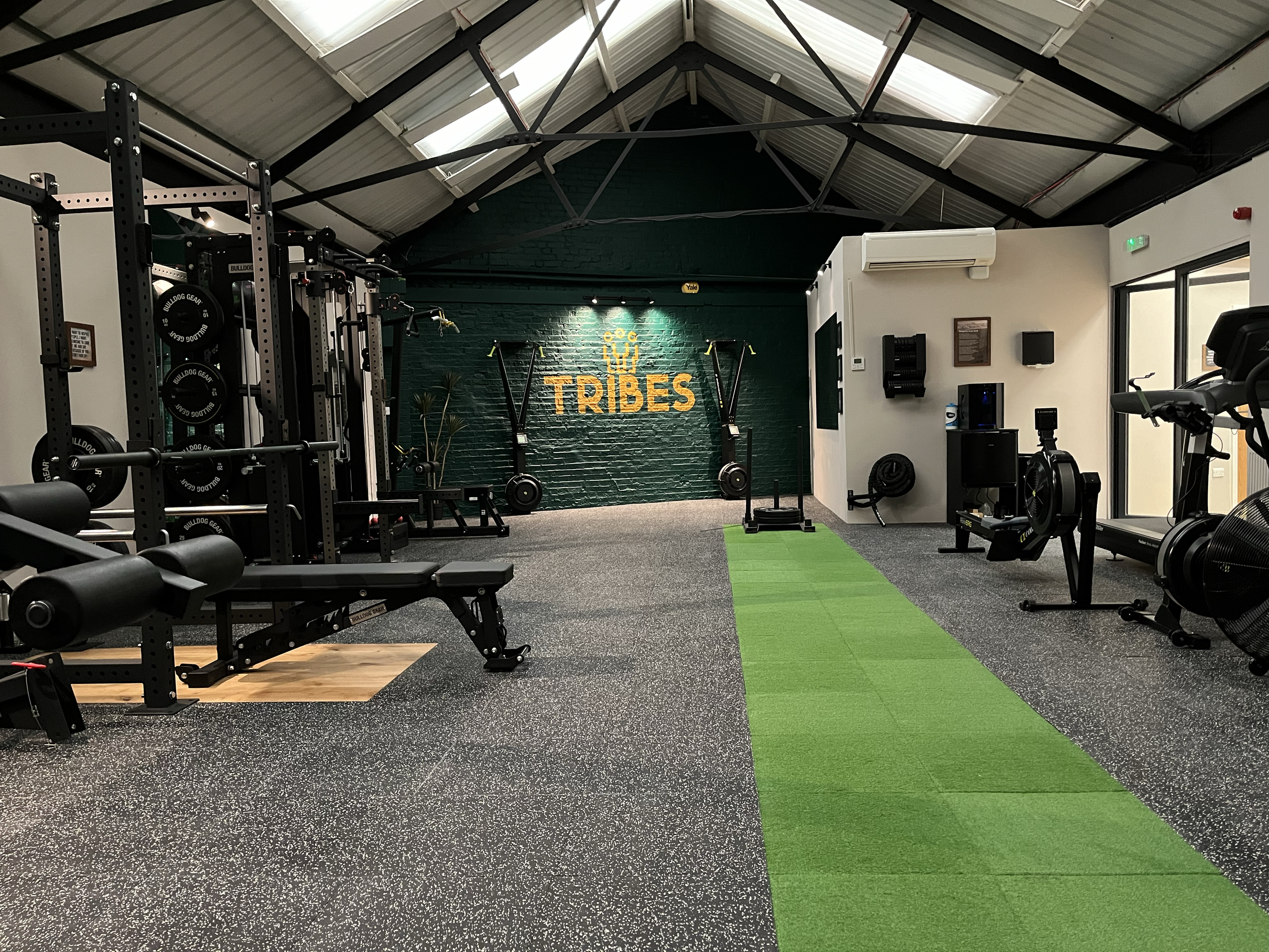 modern gym interior with exercise equipment and Tribes logo. TRIBES St John's Wood, London NW8 0JT..